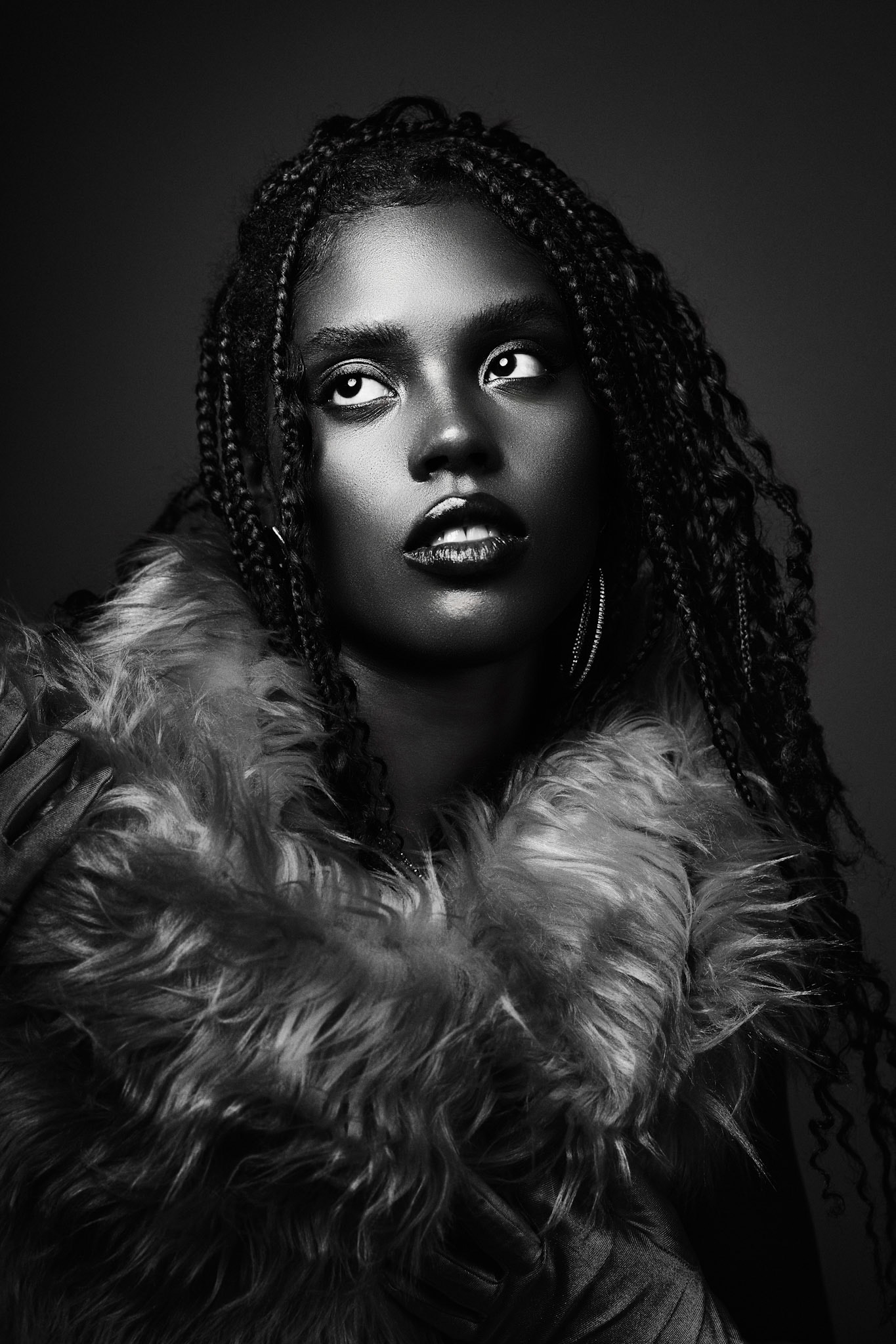 Black-and-white portrait looking upward in a textured wrap