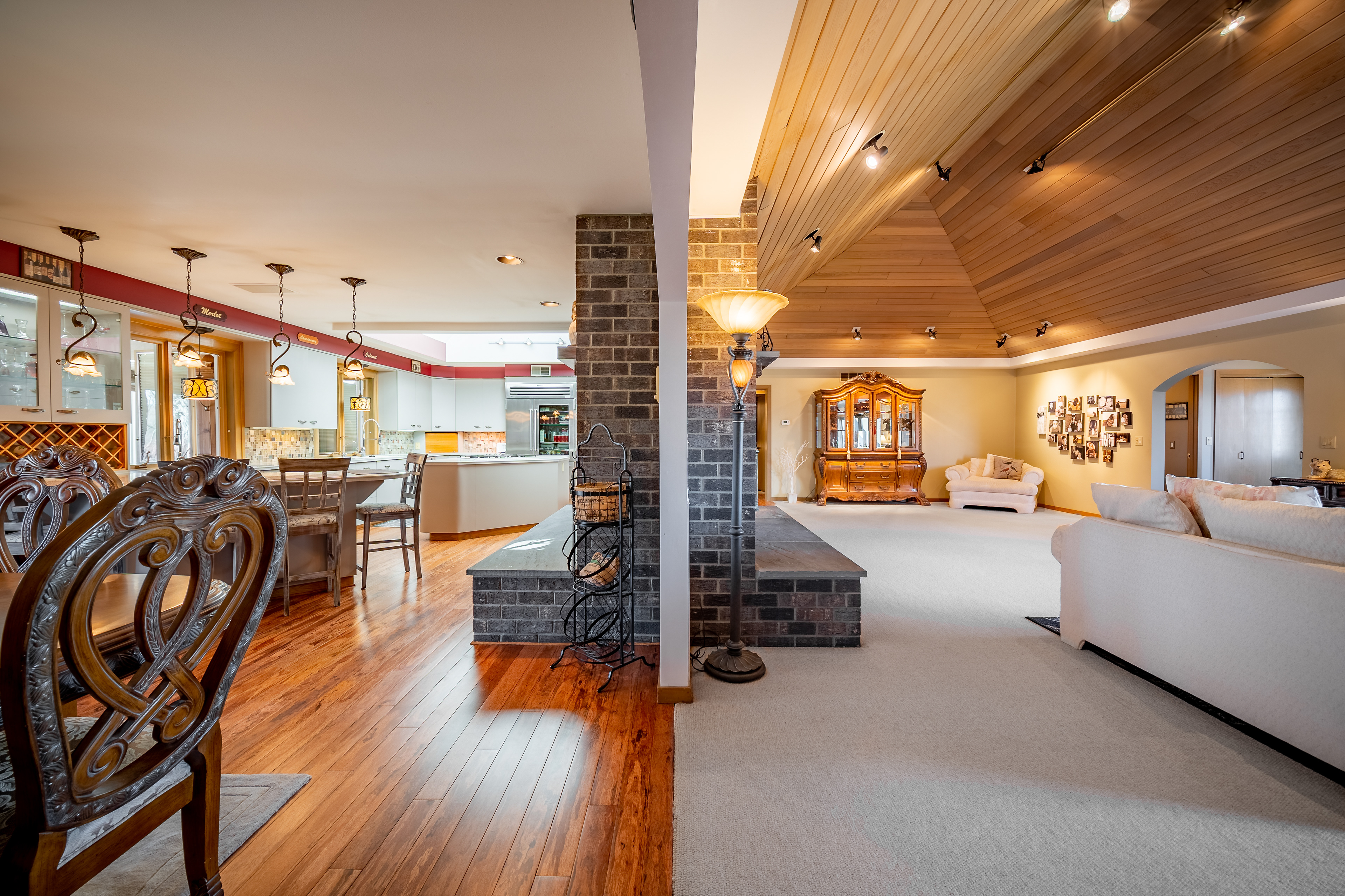 Photo shot with wide lens, showcasing both a kitchen and living room in a single image.