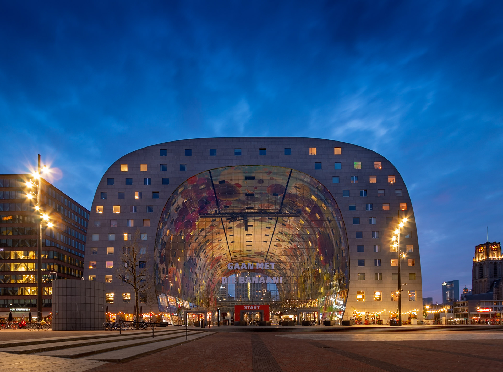Rotterdam, Netherlands - April 14 2018: Blue hour at the famous Markthal, an indoor foodhall with an amazing ceiling.