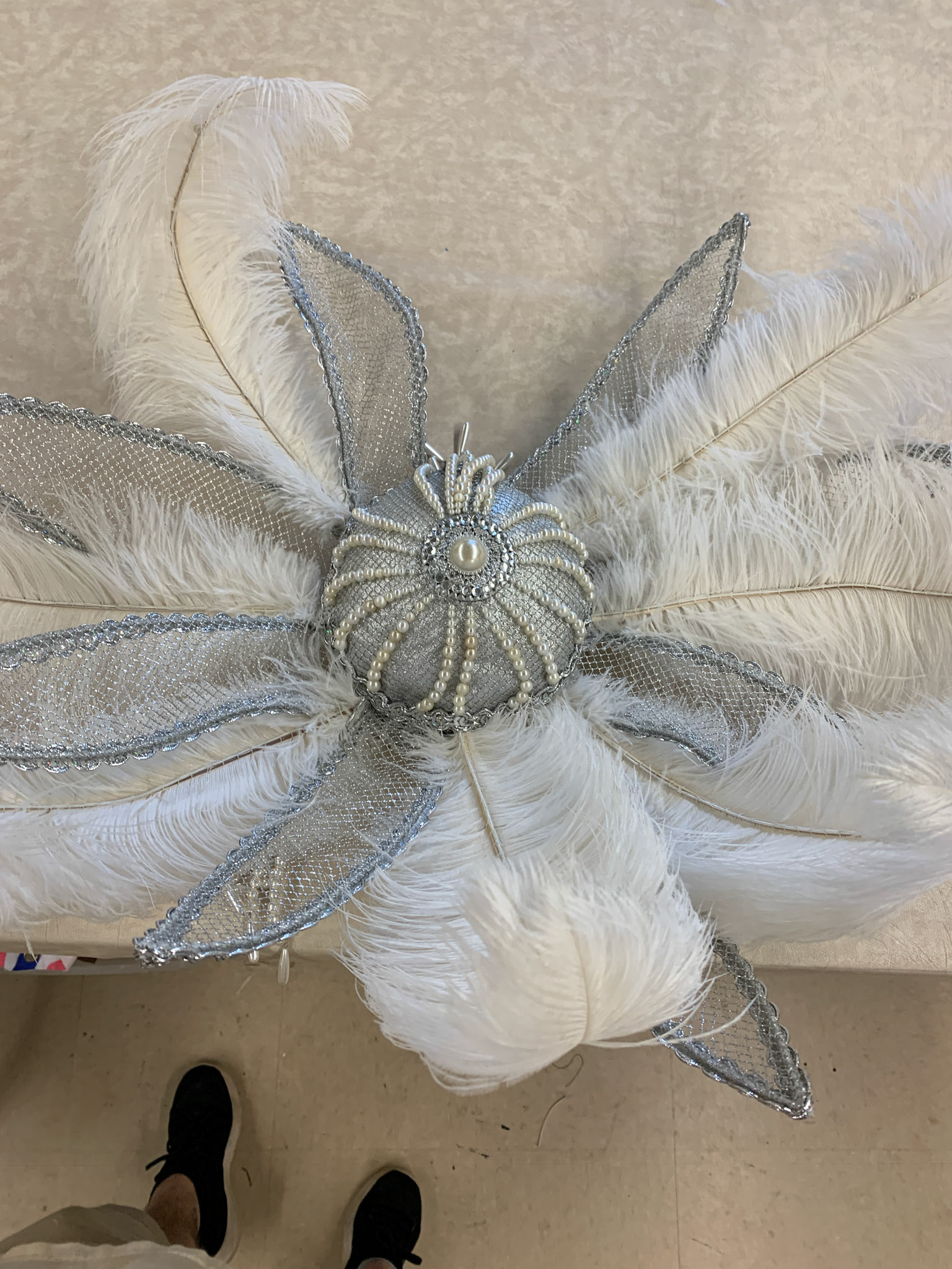 applied trim and feathers to show girl cap