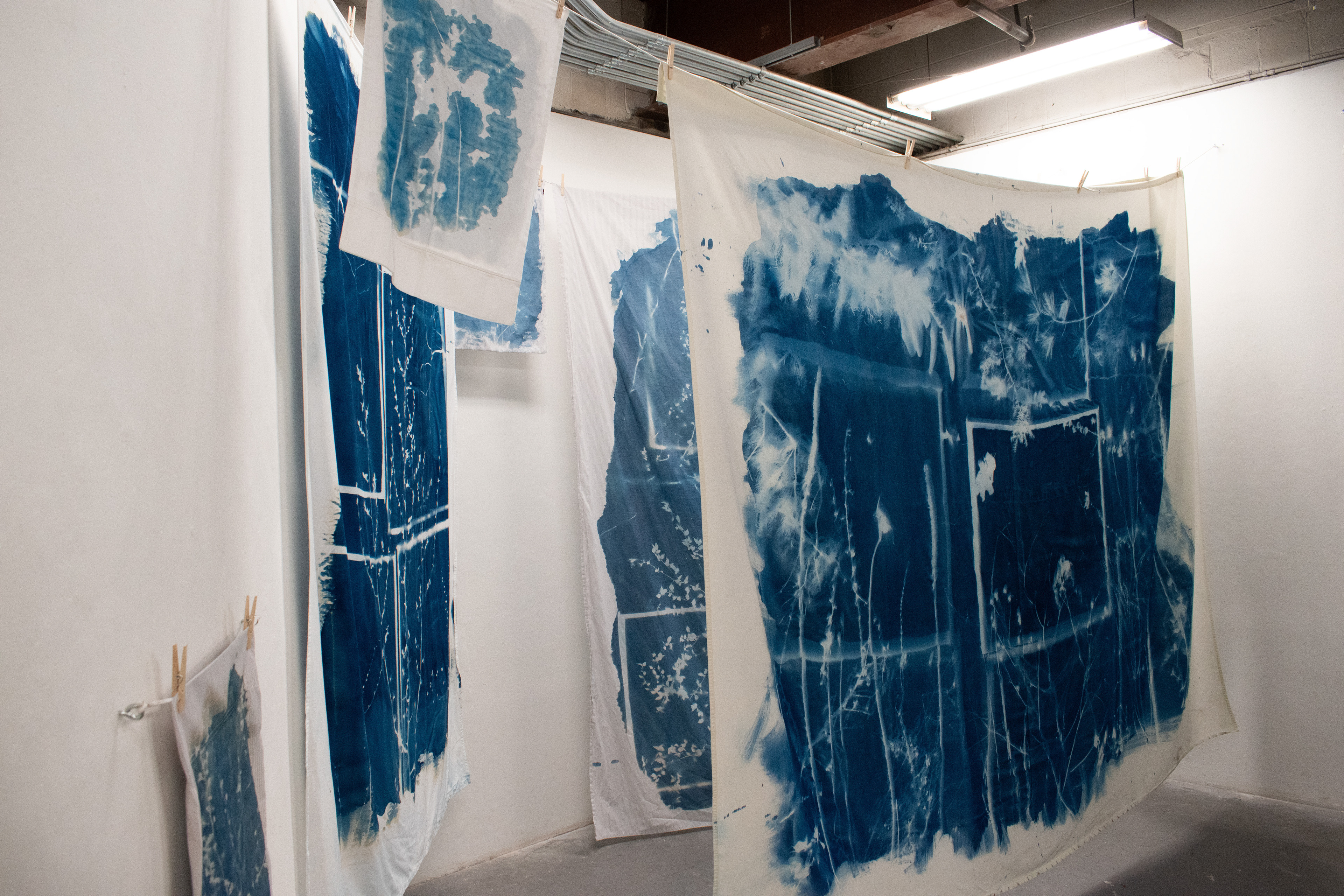 "My Hideaway;" cyanotyped bedding, clothes line; 2024