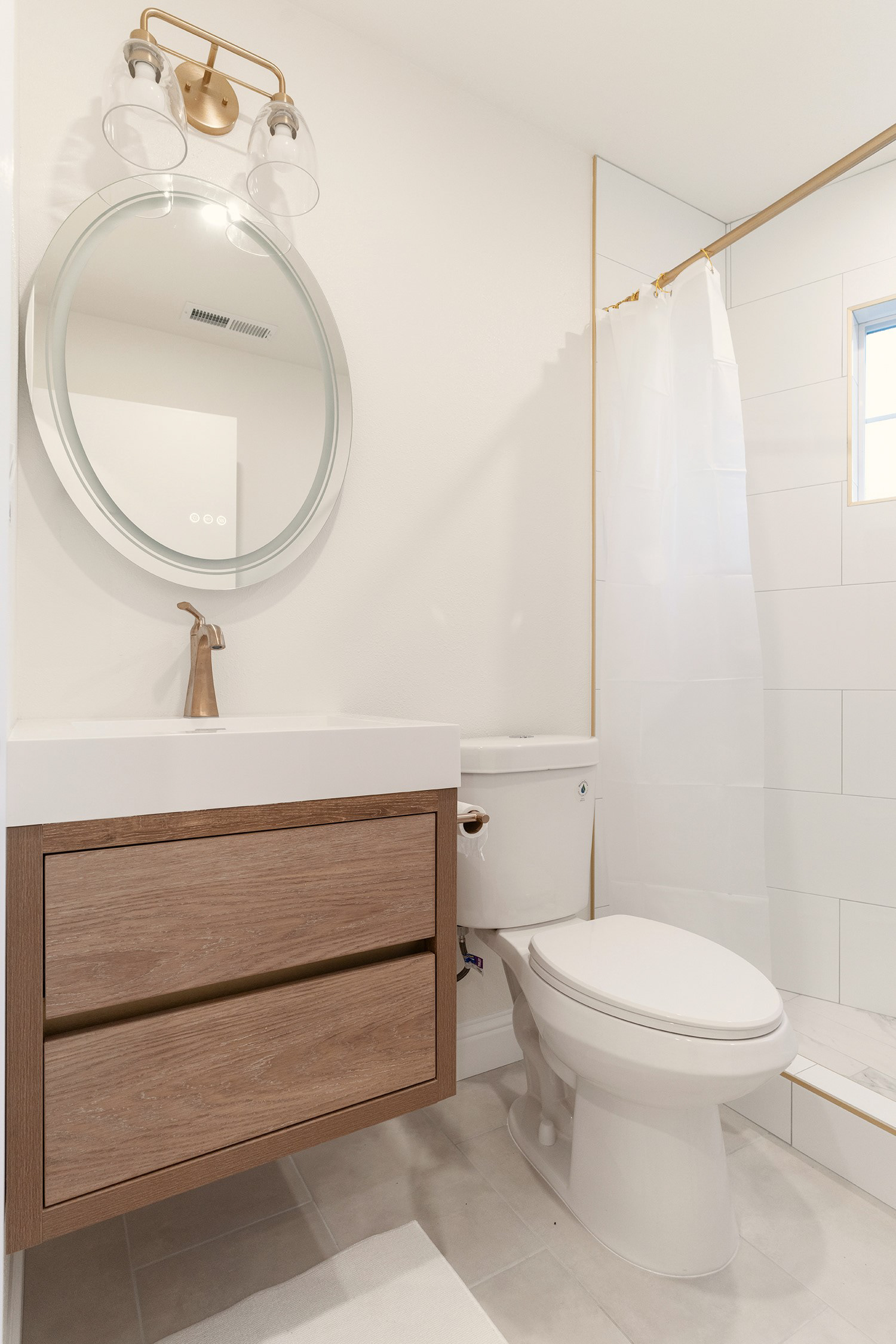 New bathroom with mirror and a floating wood vanity
