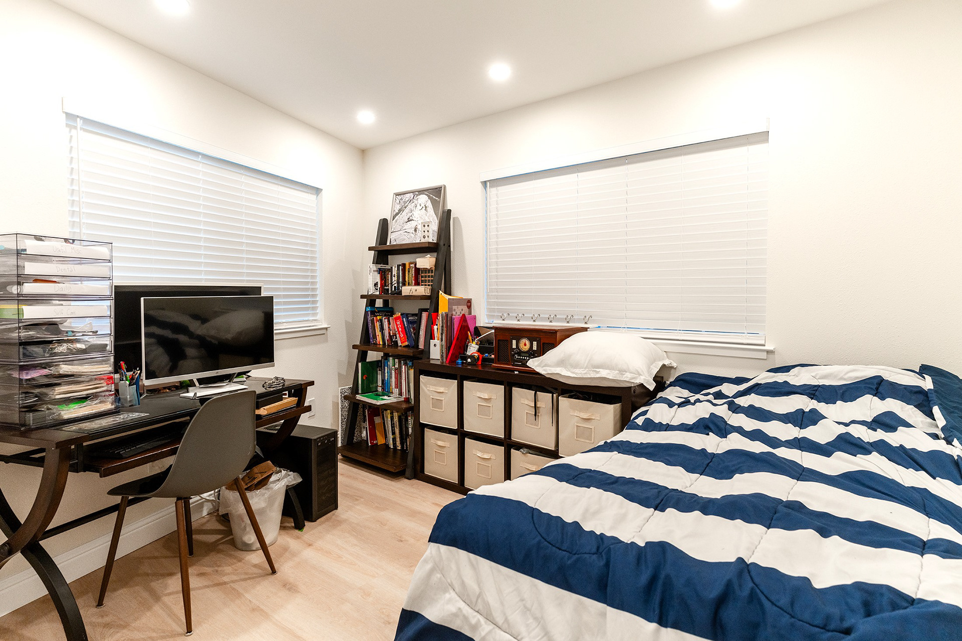 A comfortable kid's bedroom with two windows
