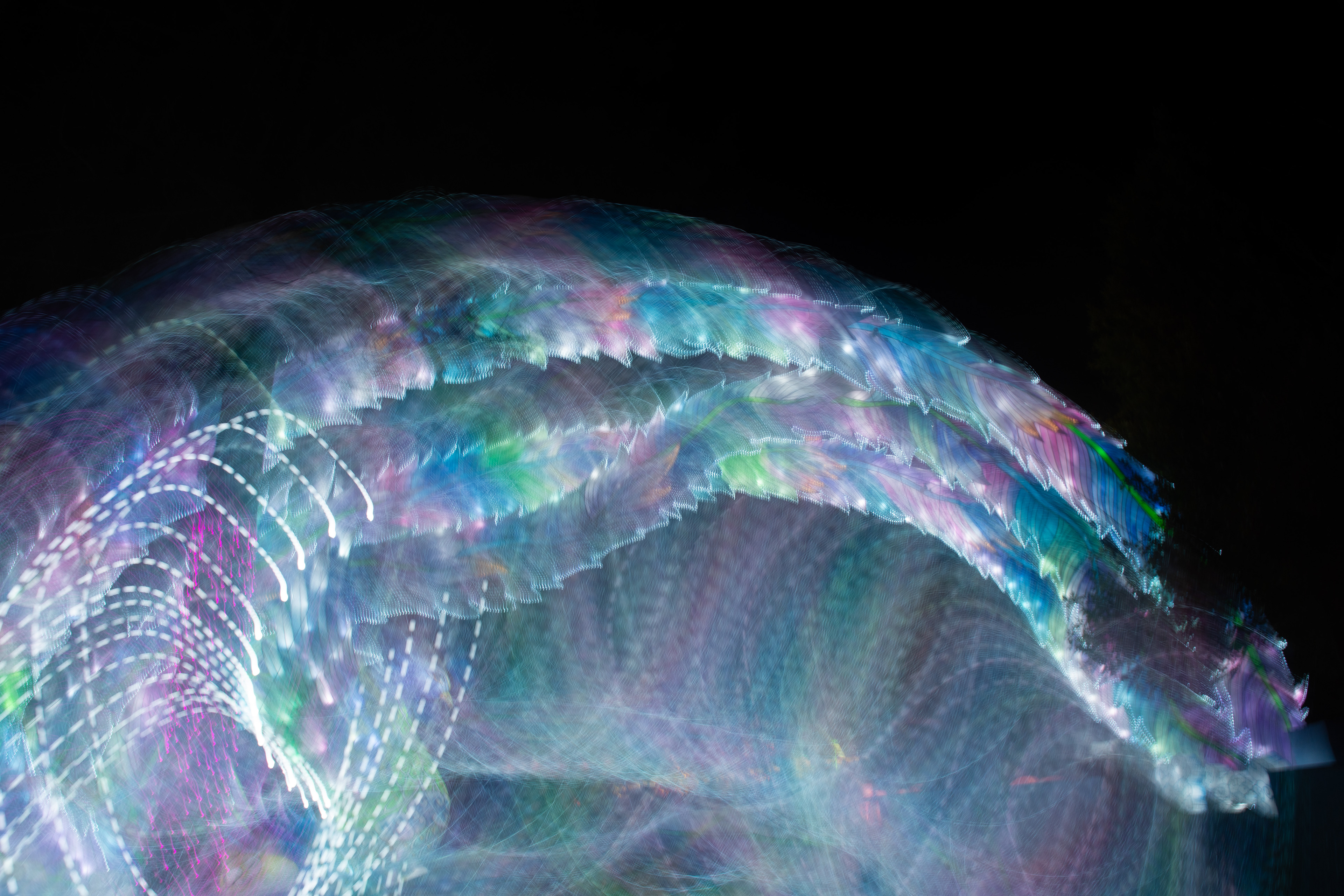 'Aurora Borealis' (2025).  A mesmerising dance of ethereal colours swirls across the canvas, reminiscent of a mystical sea creature gliding through the depths of an enchanted ocean. Iridescent blues and purples intertwine with shimmering pinks and greens, creating a luminous tapestry that seems to pulse with life. The flowing form, like a celestial ribbon, weaves a tale of wonder and magic, casting a spell of vibrant hues against the midnight backdrop. It's as if the aurora borealis has descended to perform a graceful ballet, leaving trails of stardust in its wake.