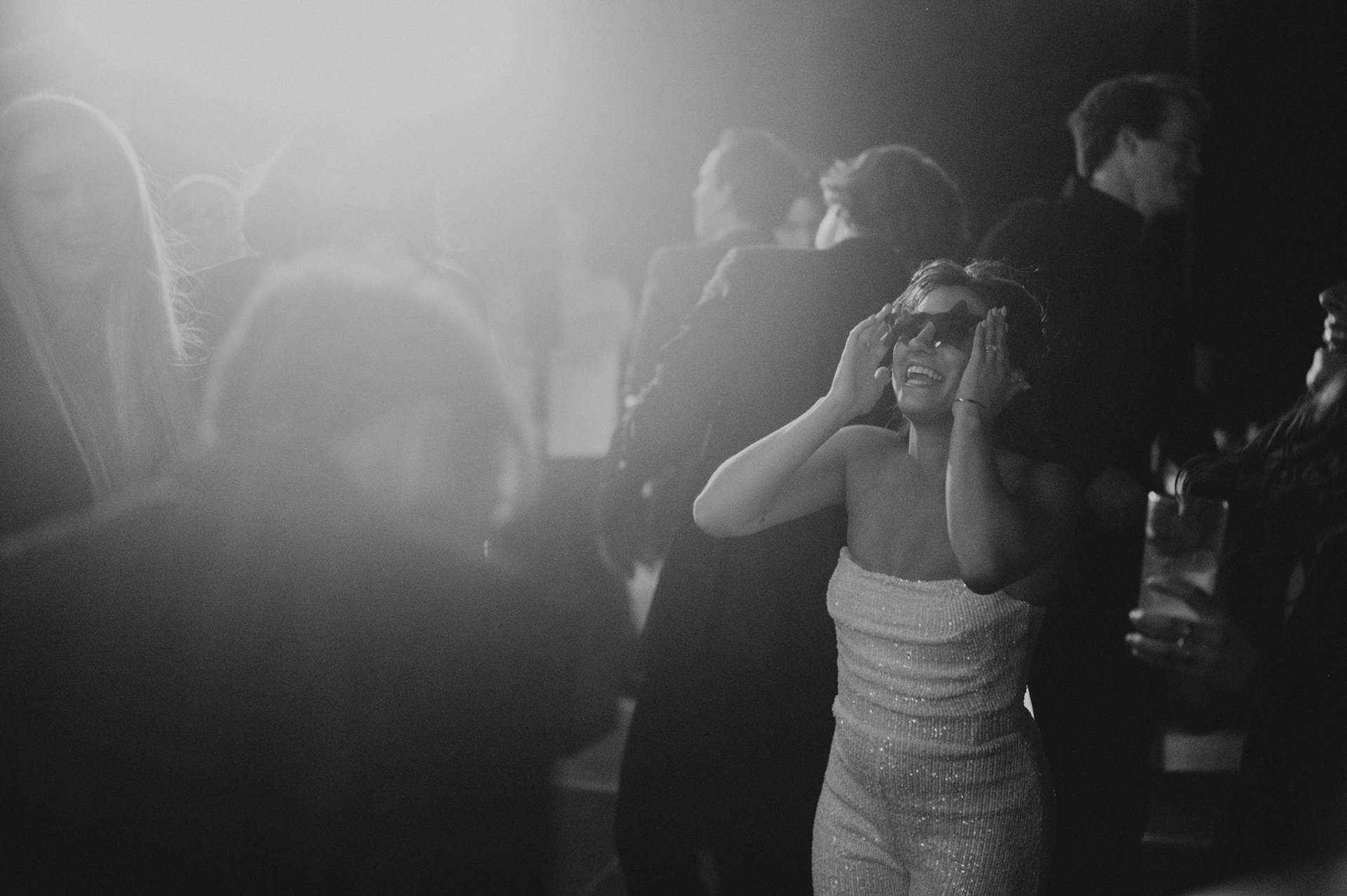 Cami, Tyler, and their guests celebrating beneath the string lights at Everline Resort.
