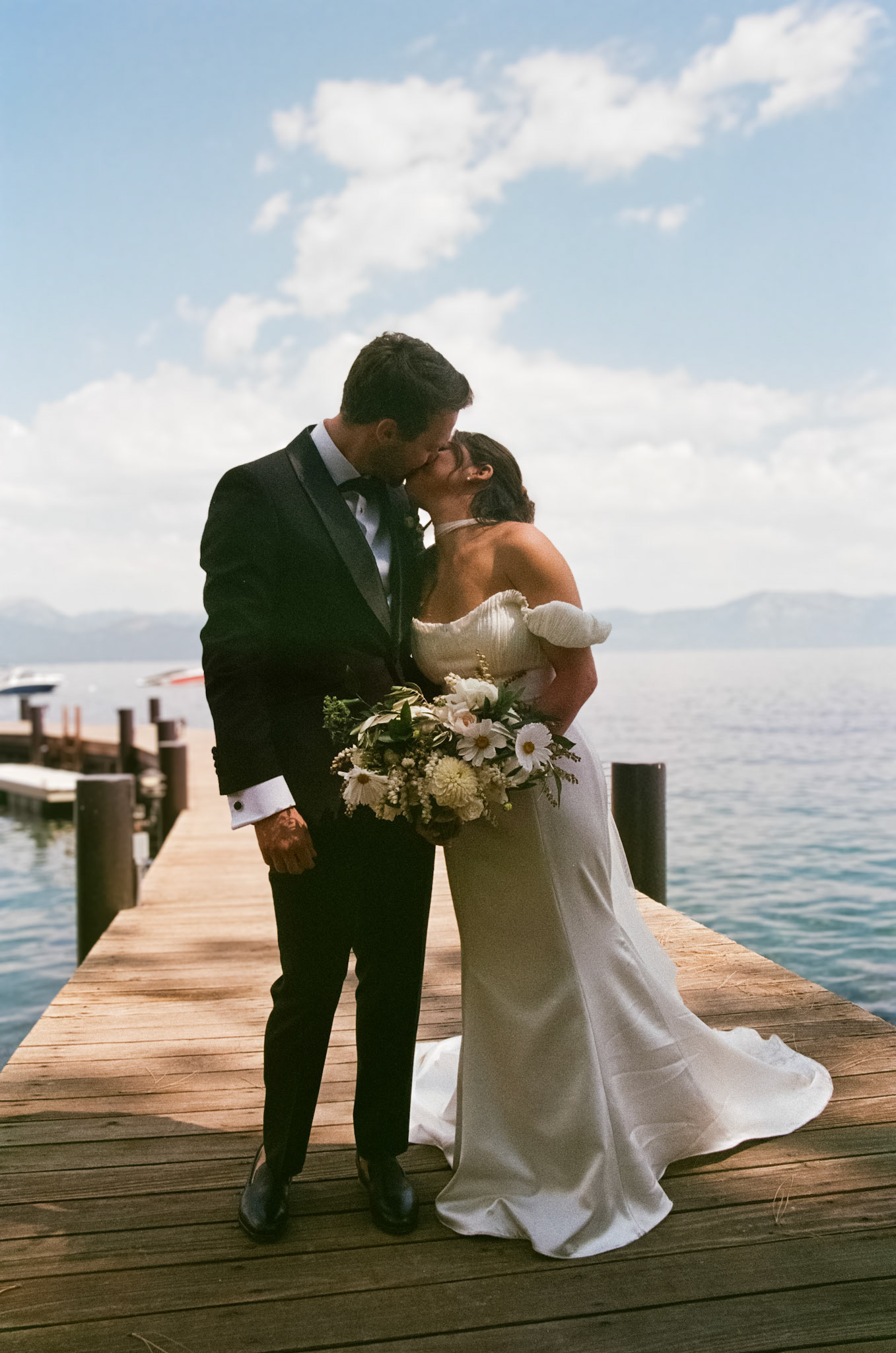 Cami, Tyler, and their guests celebrating beneath the string lights at Everline Resort.