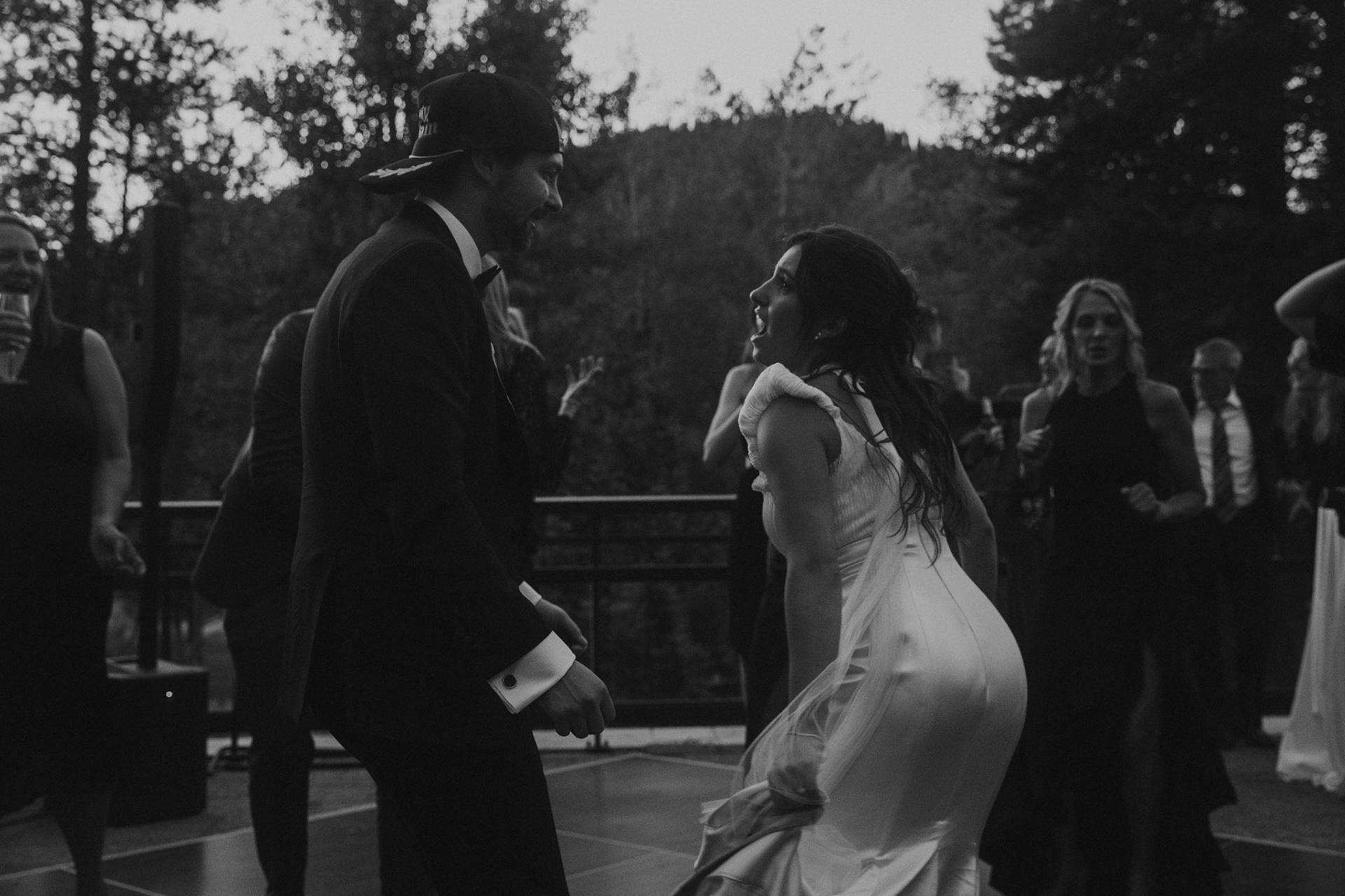 Cami, Tyler, and their guests celebrating beneath the string lights at Everline Resort.