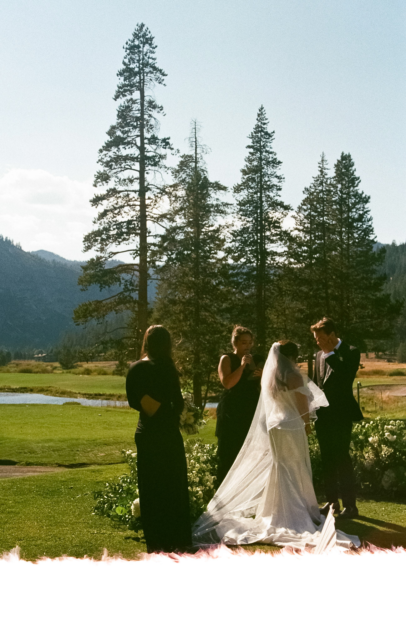 Cami, Tyler, and their guests celebrating beneath the string lights at Everline Resort.