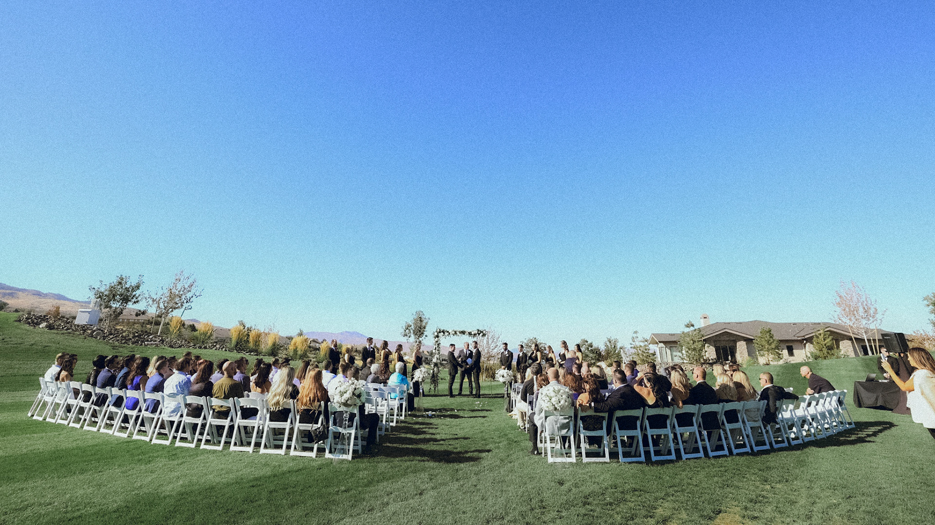 An outdoor wedding ceremony overlooking the Sierra Nevada at The Club at ArrowCreek.