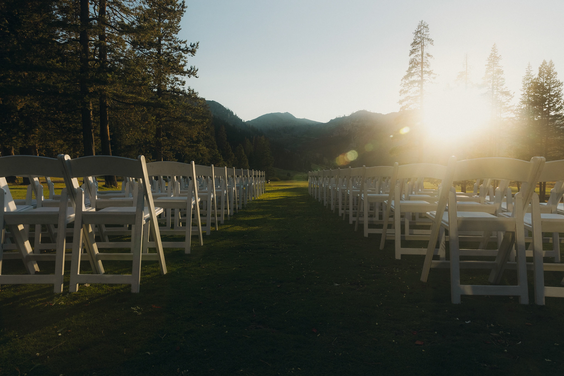Cami, Tyler, and their guests celebrating beneath the string lights at Everline Resort.
