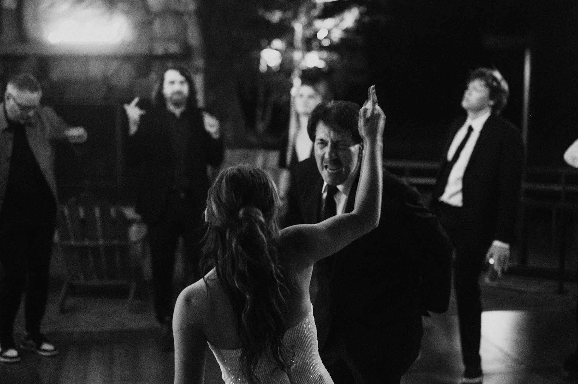 Cami, Tyler, and their guests celebrating beneath the string lights at Everline Resort.