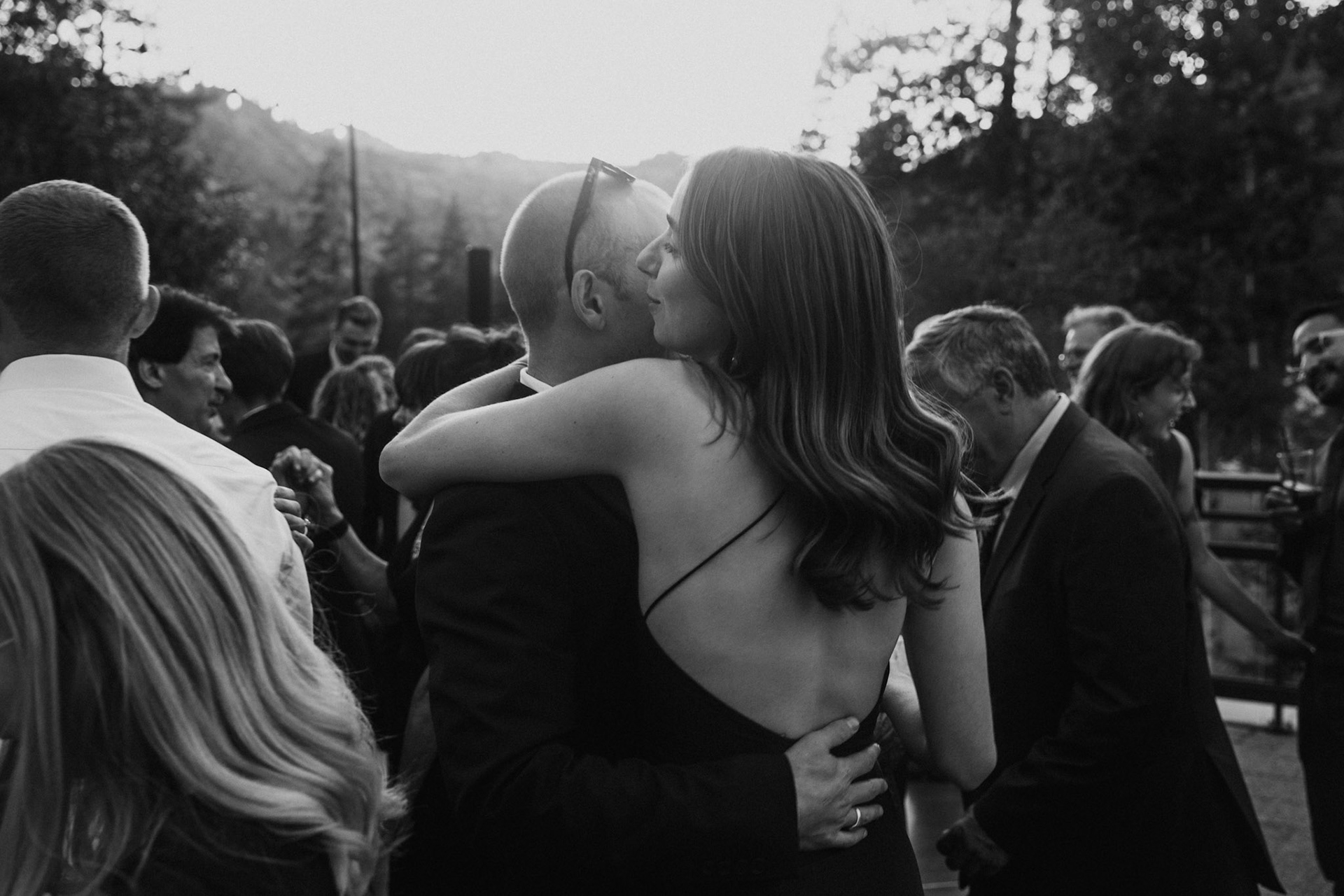 Cami, Tyler, and their guests celebrating beneath the string lights at Everline Resort.
