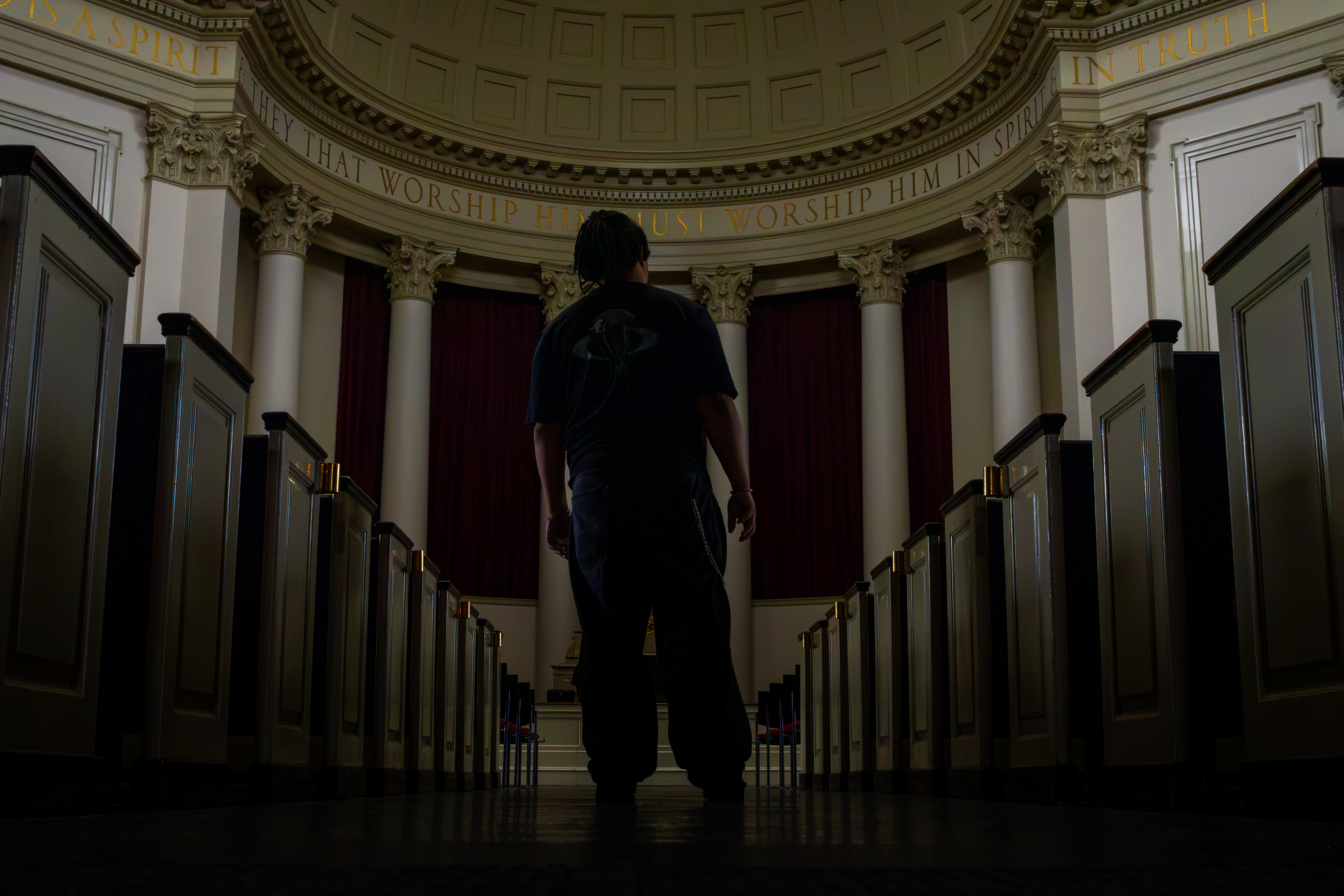 Person standing beneath the domed interior Hendricks Chapel.