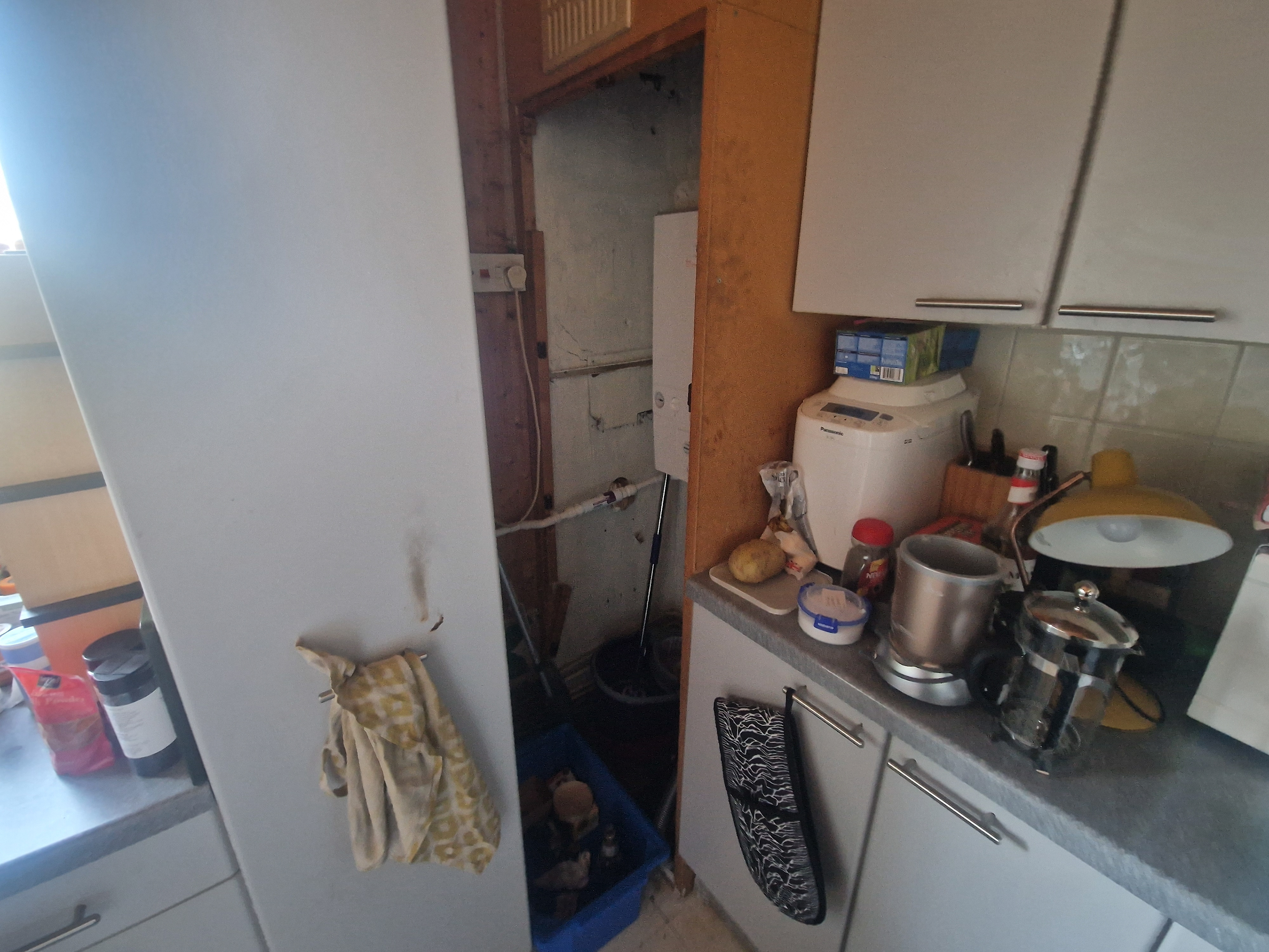 CRAMPED UNUSABLE CORNER WITH INACCESIBLE BOILER AND PIPEWORK