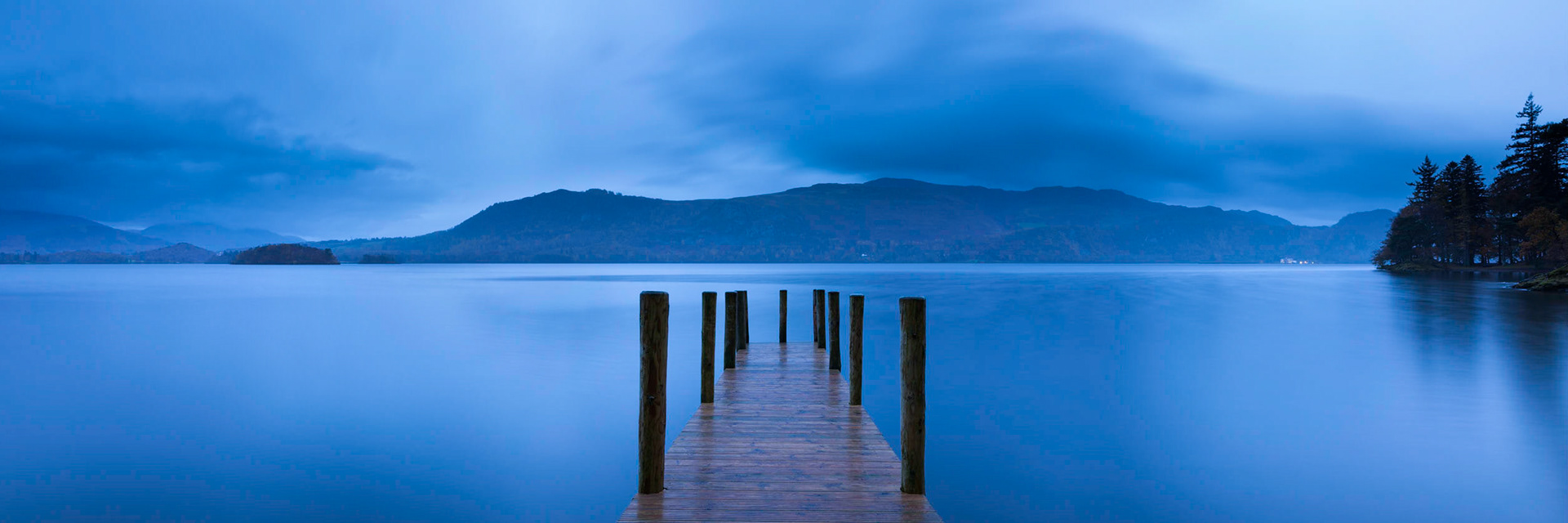 High Brandelhow jetty on Derwent Water before sunrise, The Lake District, England.