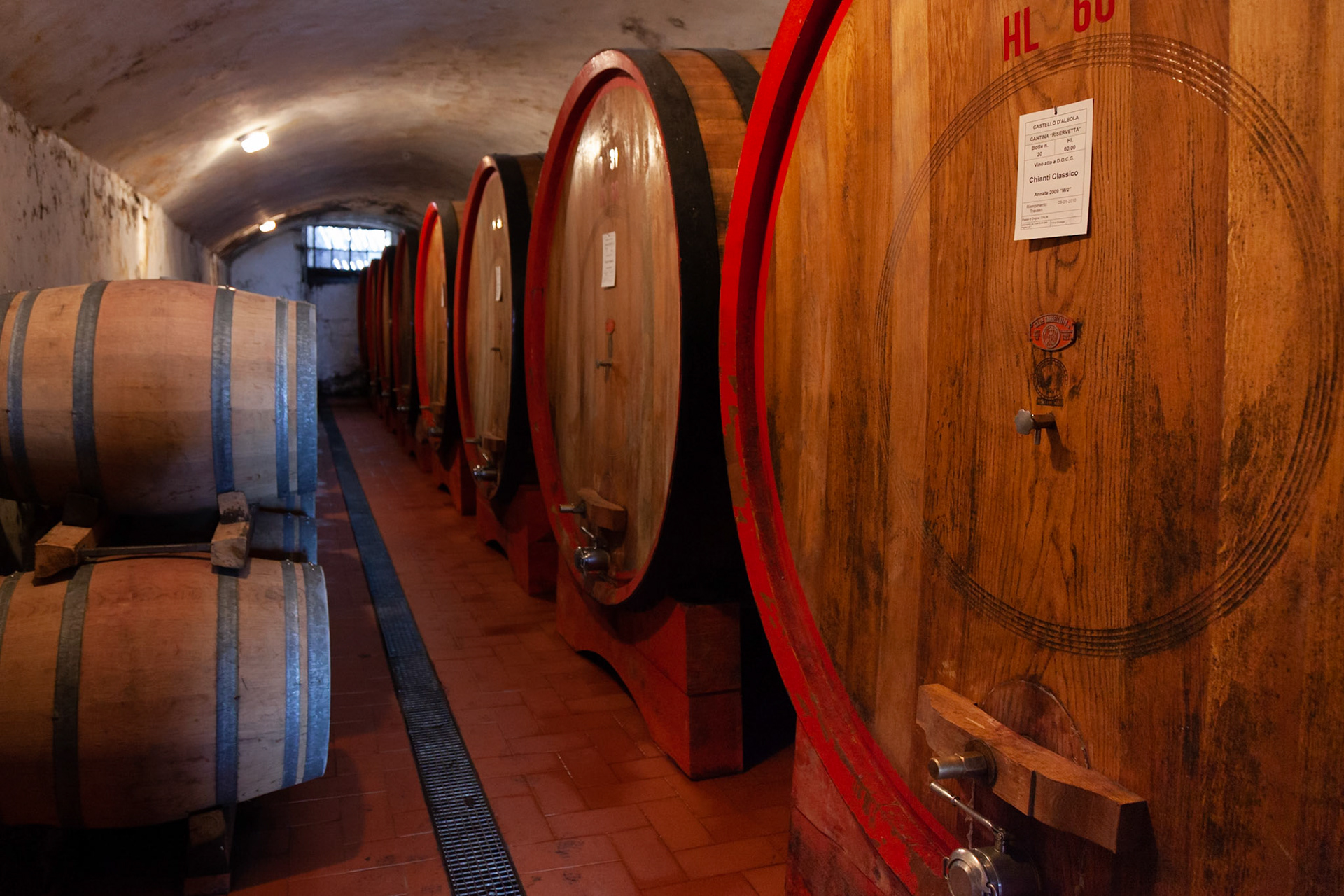 Inside a cellar at Fattoria di Albola where Chianti Classico is aged in huge oak barrels, near Radda in Chianti, Tuscany, Italy.