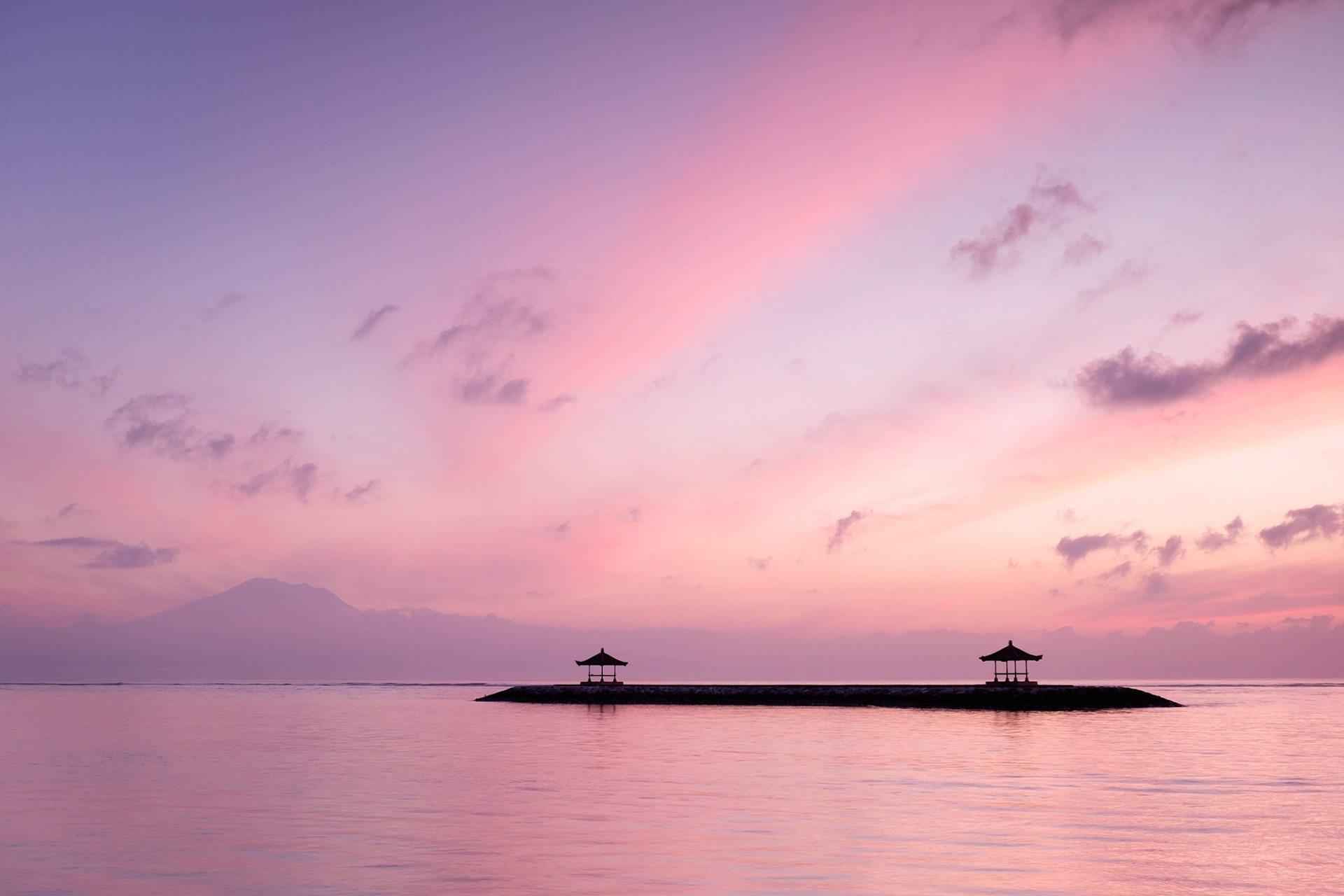 A pretty sunrise from Pantai Karang with Mount Agung visible in the distance, Sanur, Bali, Indonesia.