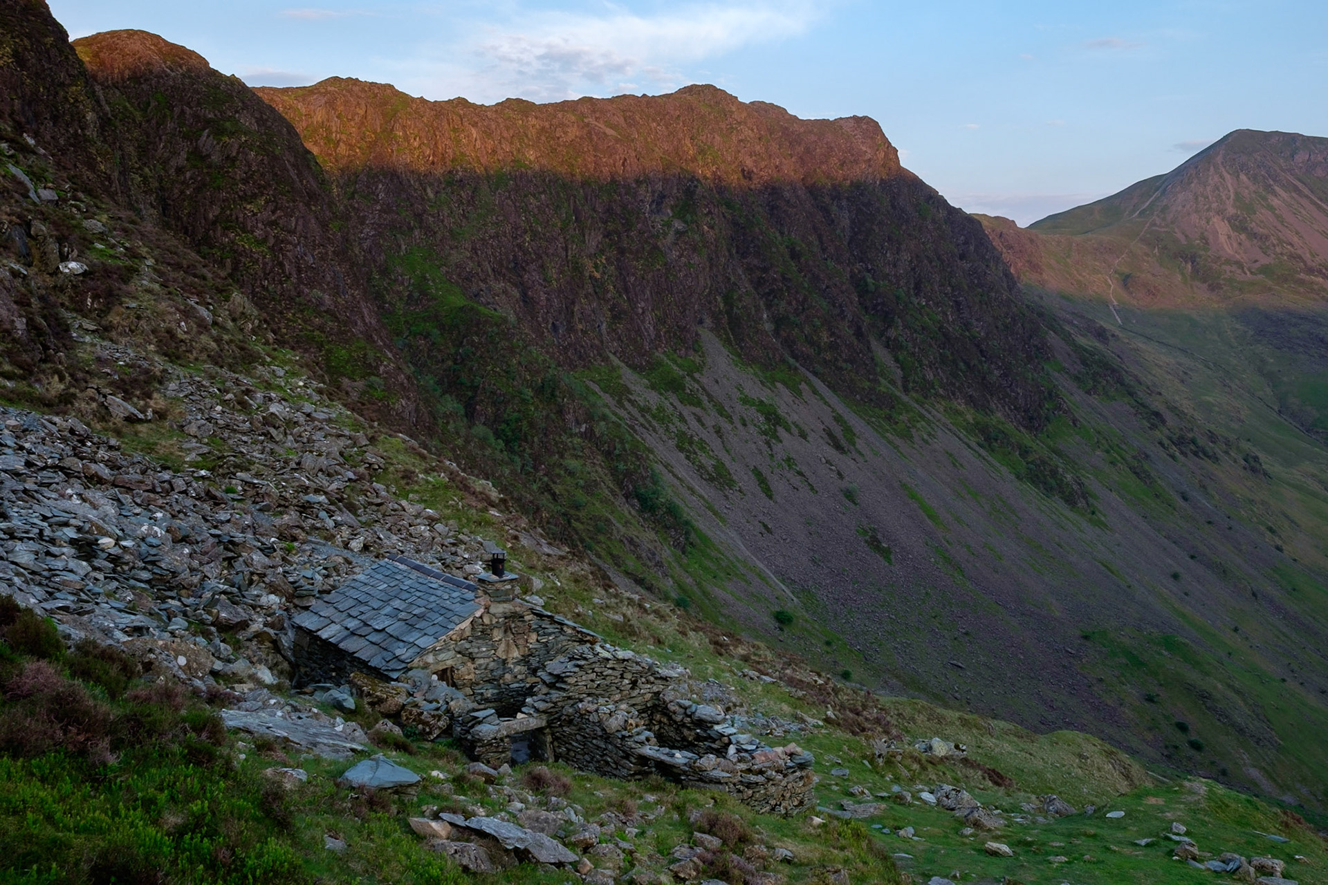 Warnscale Bothy and first light on Haystacks, Lake District National Park, England.