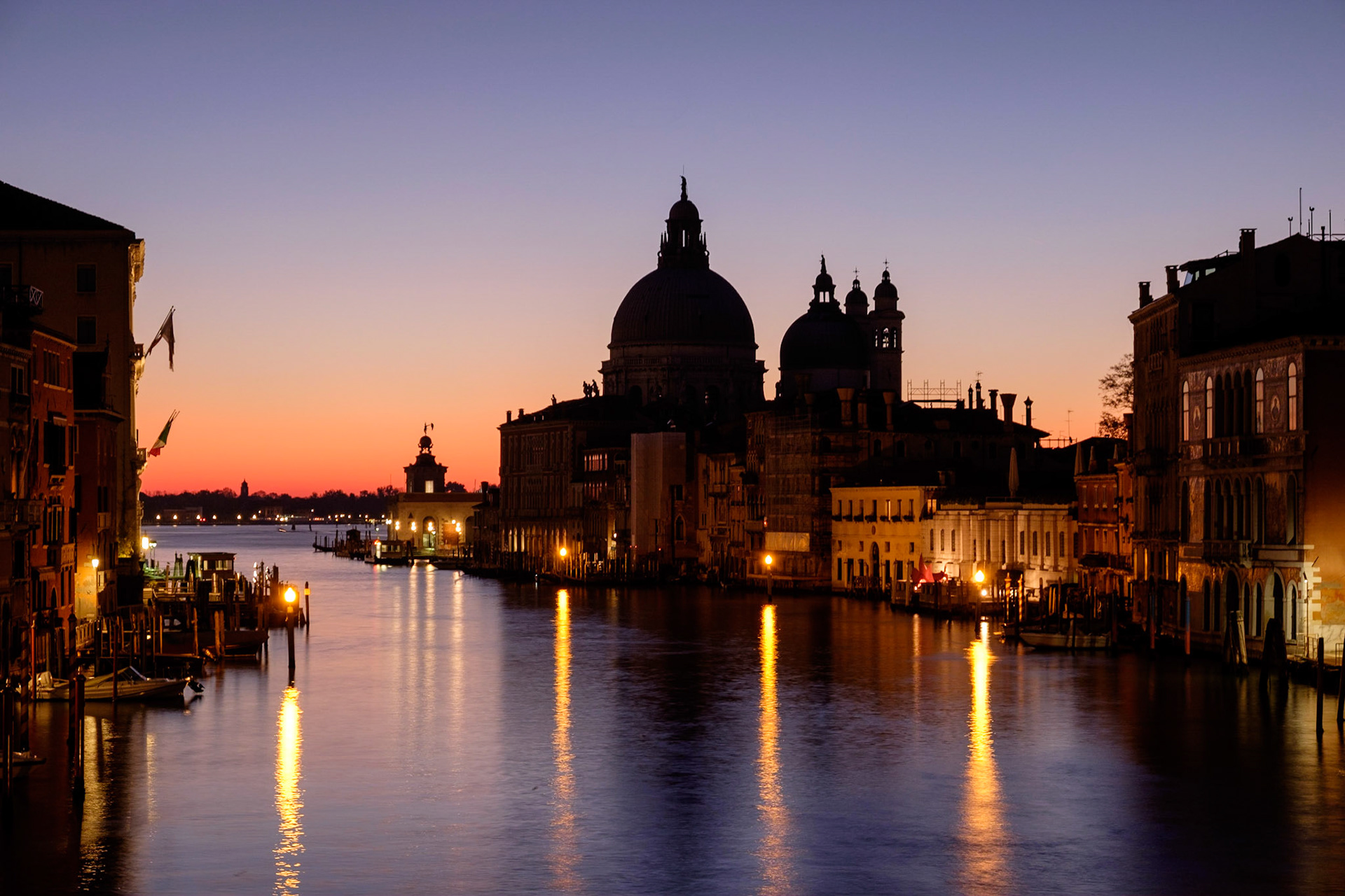 View down the Grand Canal from Ponte dell'Accademia towards the Basilica di Santa Maria della Salute at sunrise, Dorsoduro, Venice.