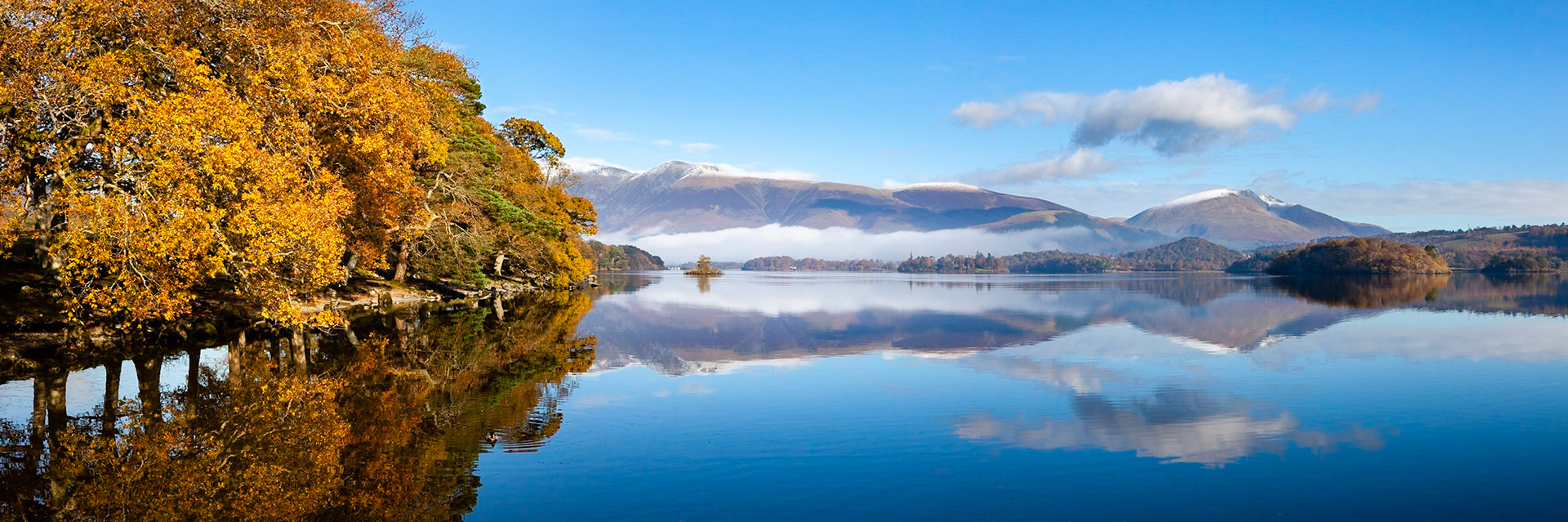 A beautiful calm autumn morning looking across Derwent Water from Low Brandelhow Landing, The Lake District, England.