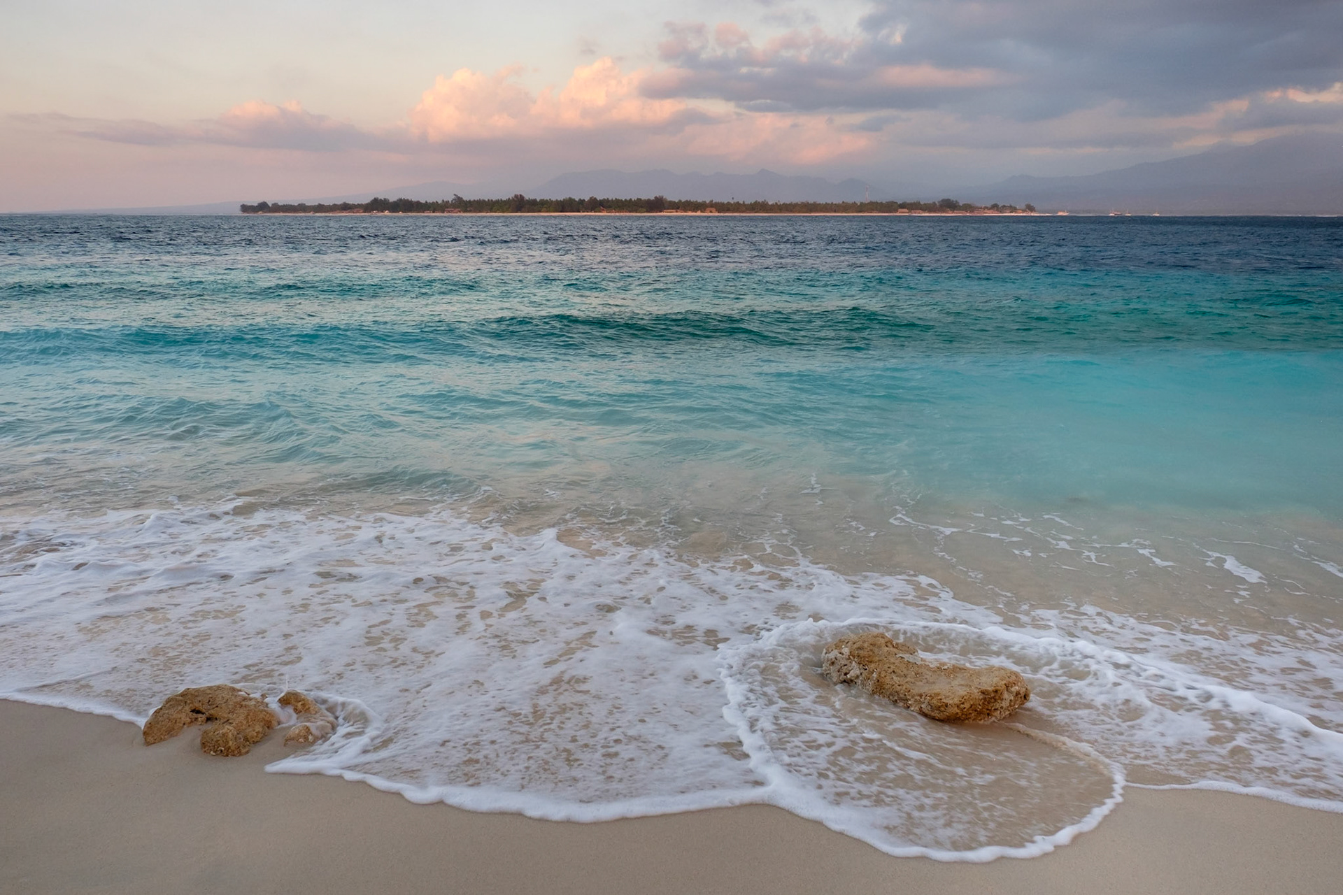Sunset on Gili Meno with Gili Air and Lombok in the distance, Gili Meno, Lombok, Indonesia.