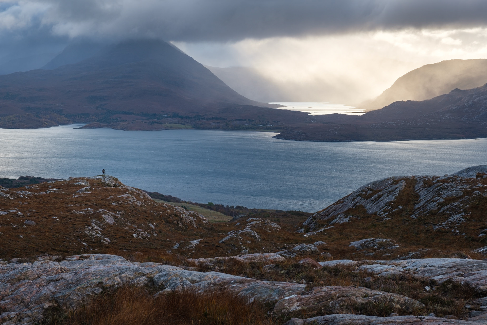 A photographer shooting the view across Loch Torridon from Bealach na Gaoithe.