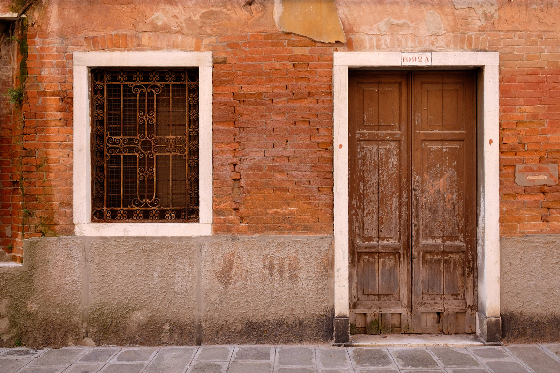 A weathered facade down a side alley in San Marco, Venice.