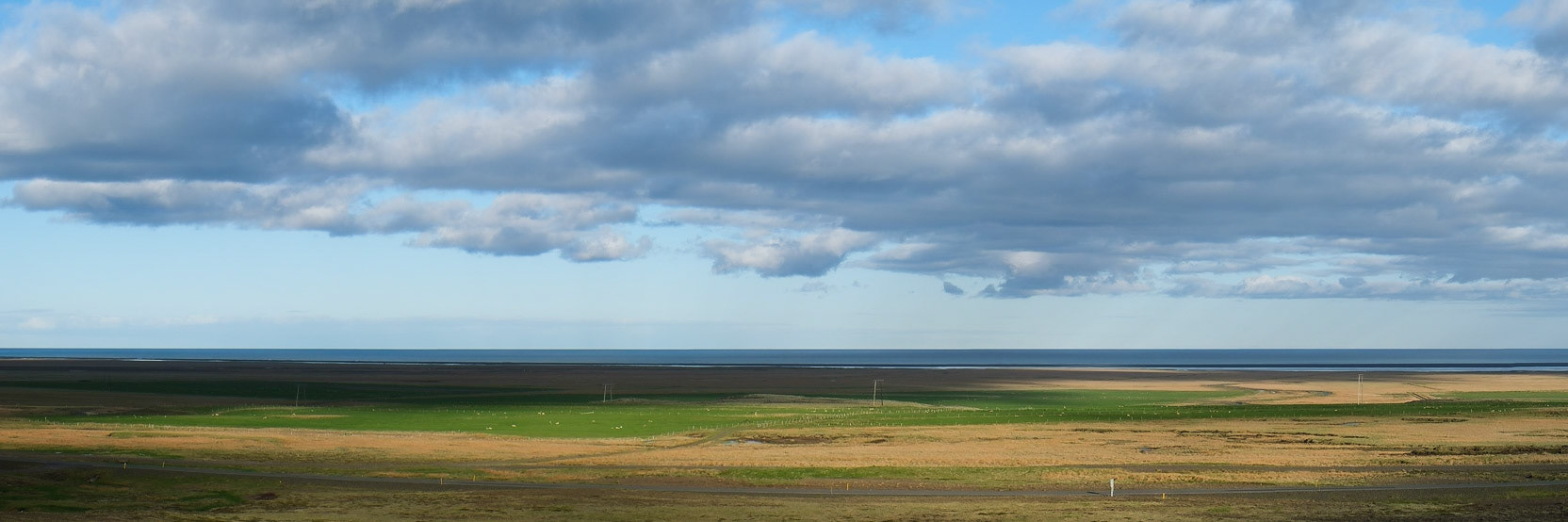 Most buildings on the South coast of Iceland are built at the base of the mountains to avoid the floods that cover the plains if there is a volcanic eruption. This gives them amazing views out to sea.