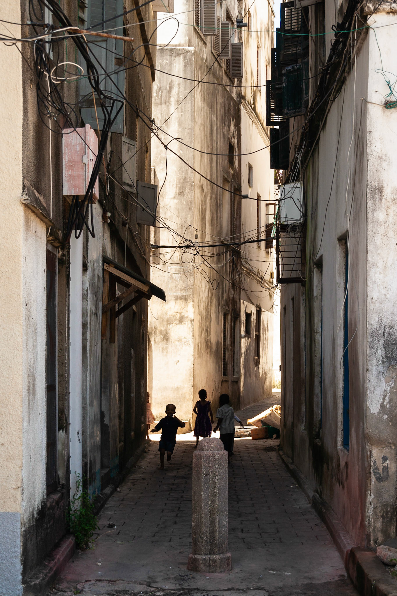 Children play in a typical alleyway, Stonetown, Zanzibar.