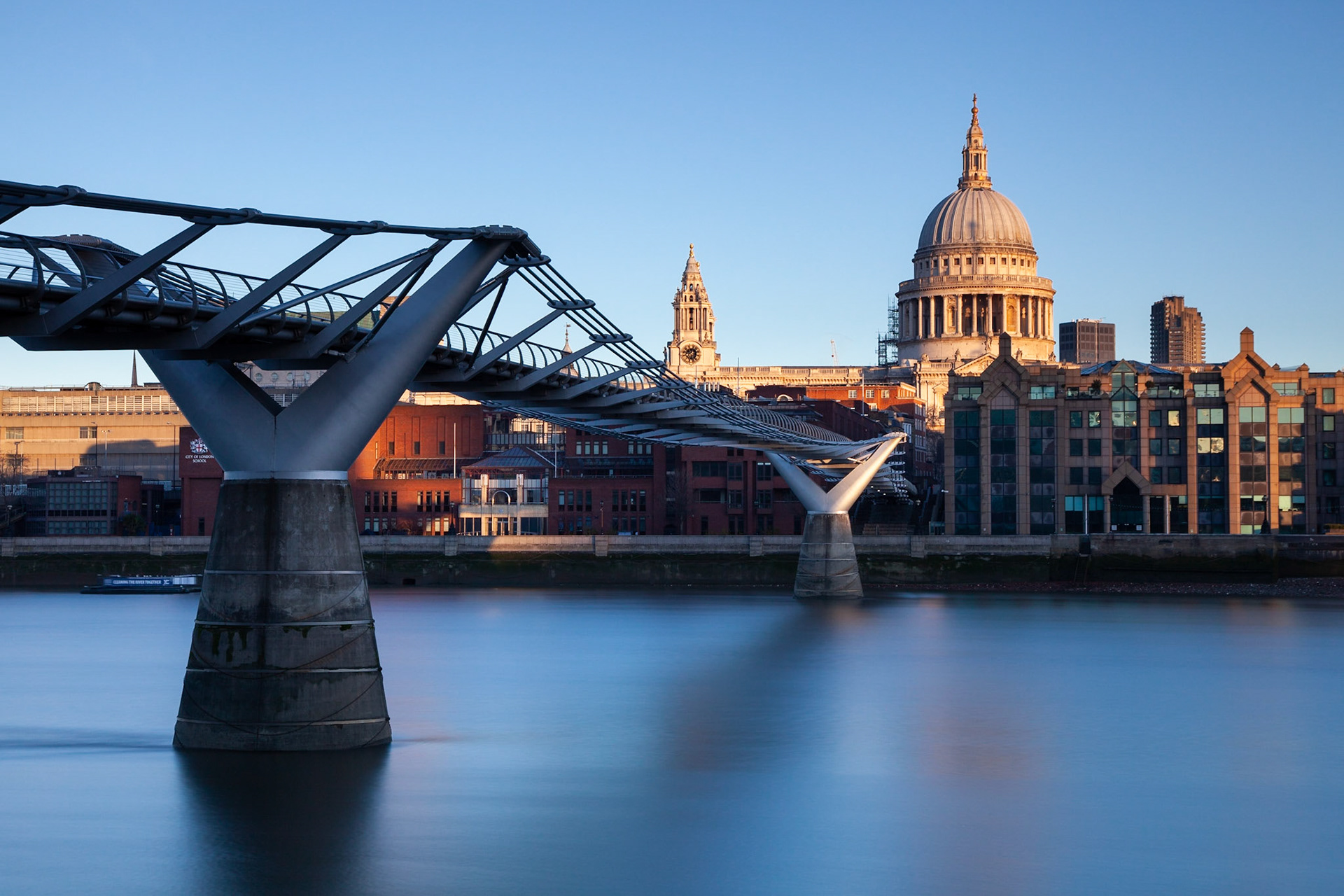 A long exposure of the Millenium Bridge with the first light of dawn on St Paul's Cathedral, London, England.