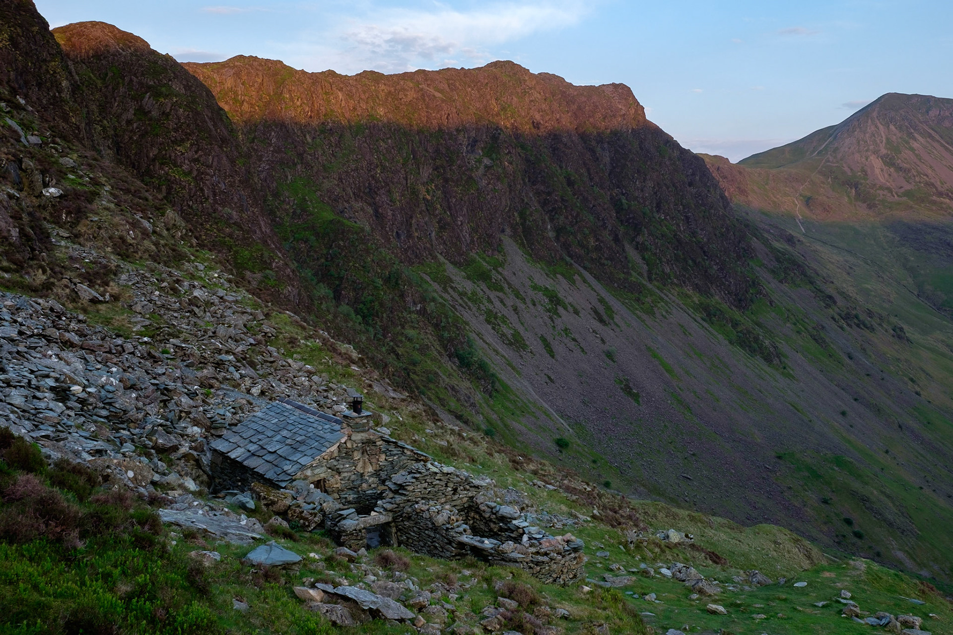 Warnscale Bothy and first light on Haystacks, Lake District National Park, England.