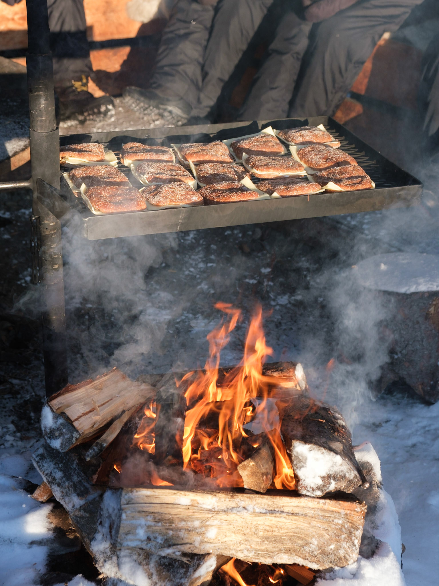 Cheese toasties getting toasted on the barbeque along with reindeer stew for lunch, Nellim, Finnish Lapland.