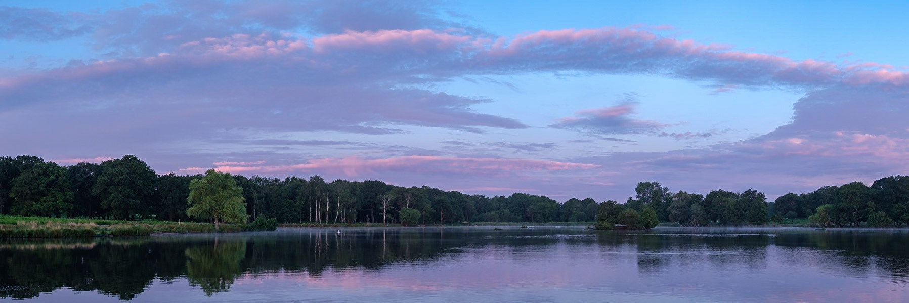 A colourful sunrise over Pen Ponds, Richmond Park.