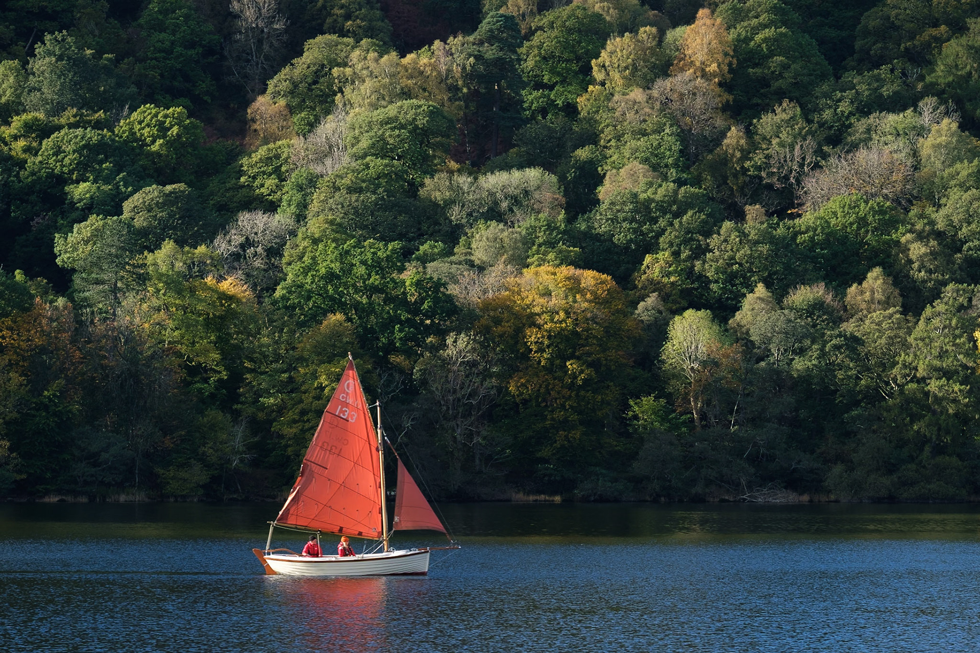 A traditional dinghy sailing on Ullswater.