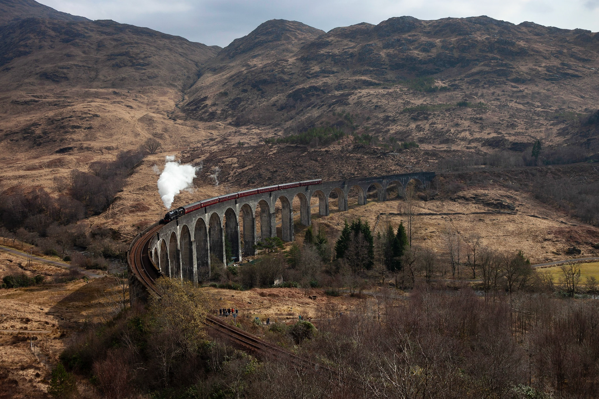 The Jacobite Express steam train (Hogwarts Express) crossing Glenfinnan Viaduct.