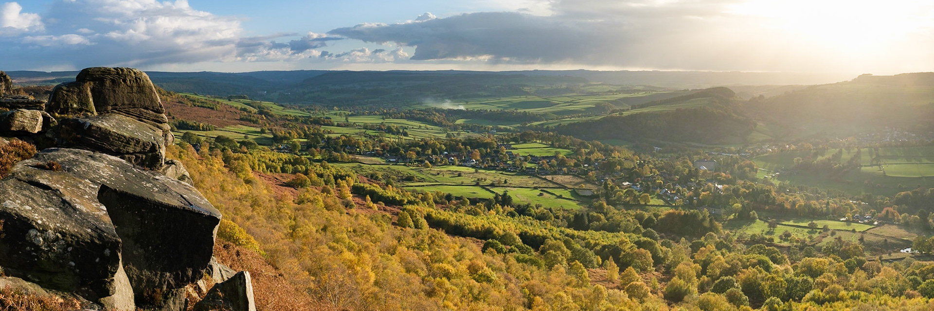 Half an hour after taking shelter from a hail storm, the sun came out and lit up the autumn colours below Curbar Edge. Peak District National Park, England.
