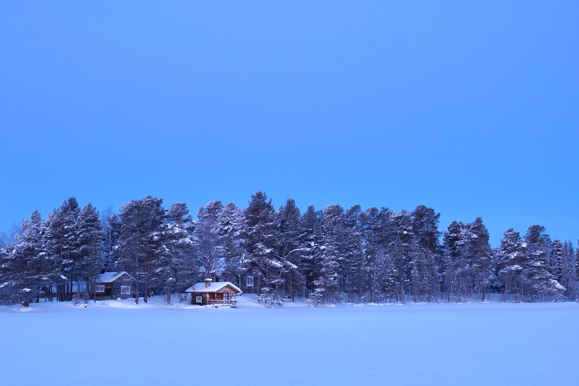 A small hut on the shores of Lake Inari at first light, Nellim, Finnish Lapland.