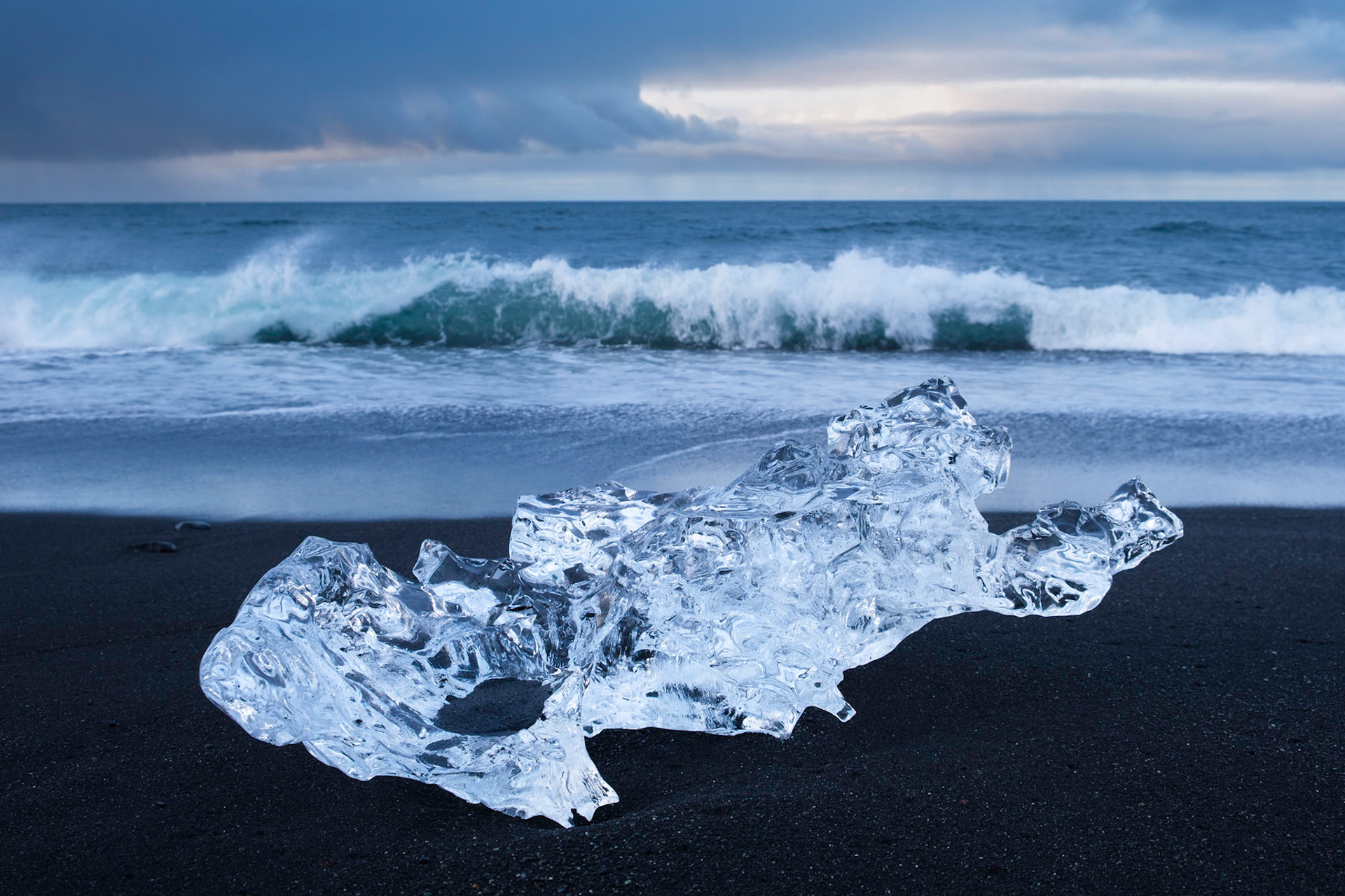 An Iceberg on a stormy morning at Jökulsárlón Ice Beach. The icebergs are washed out of Jökulsárlón lagoon at low tide and then wash up onto the beach on either side of the lagoon mouth.