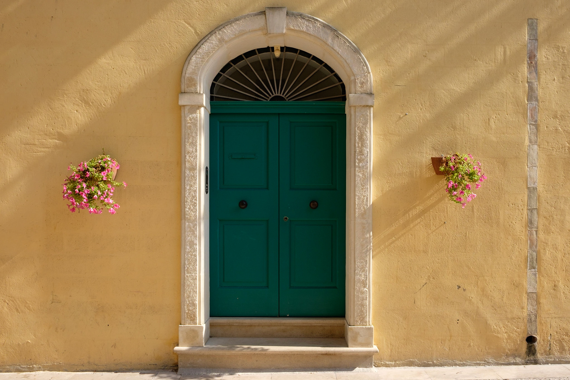Just a green door and some Petunia's in hanging baskets, Matera.