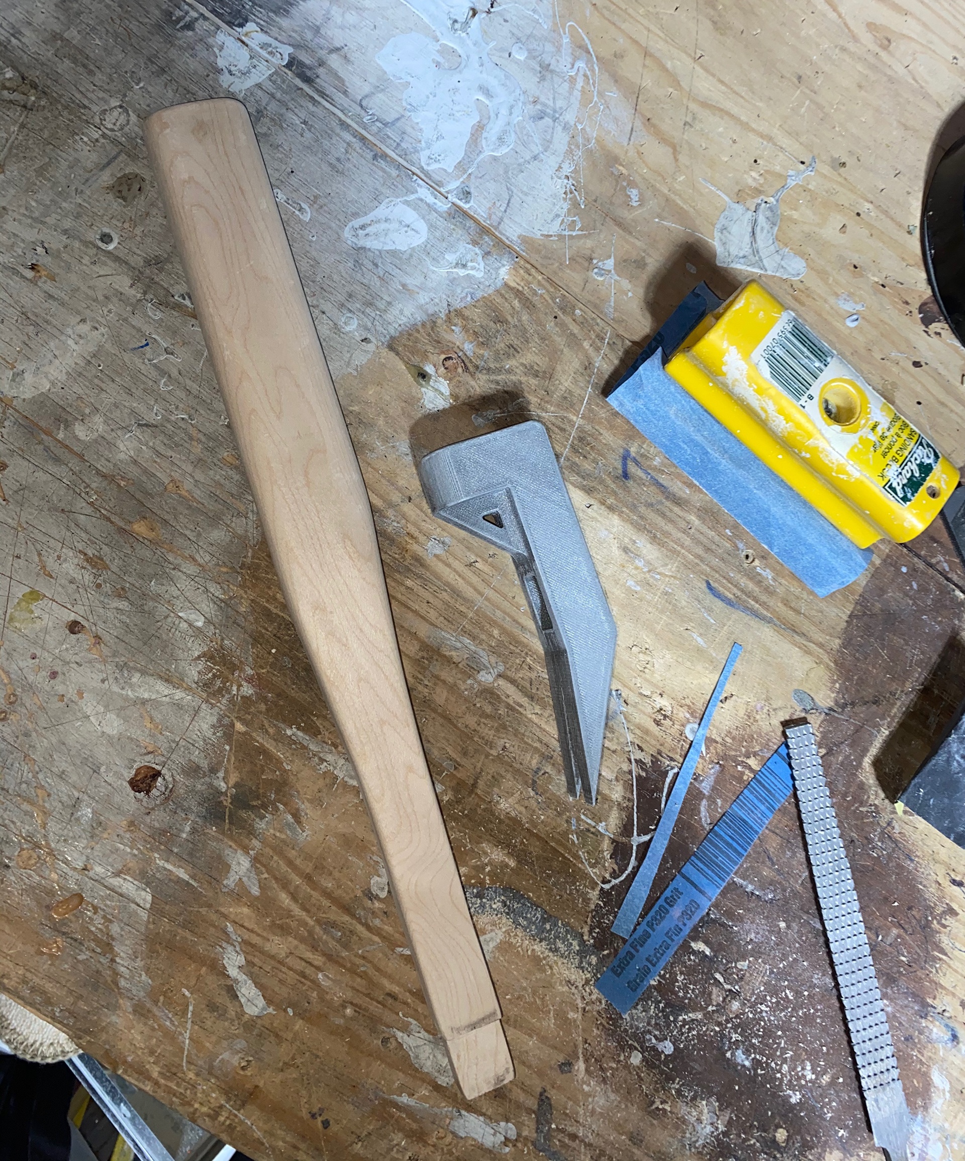 Sanding the handle to for a snug fit of the head
