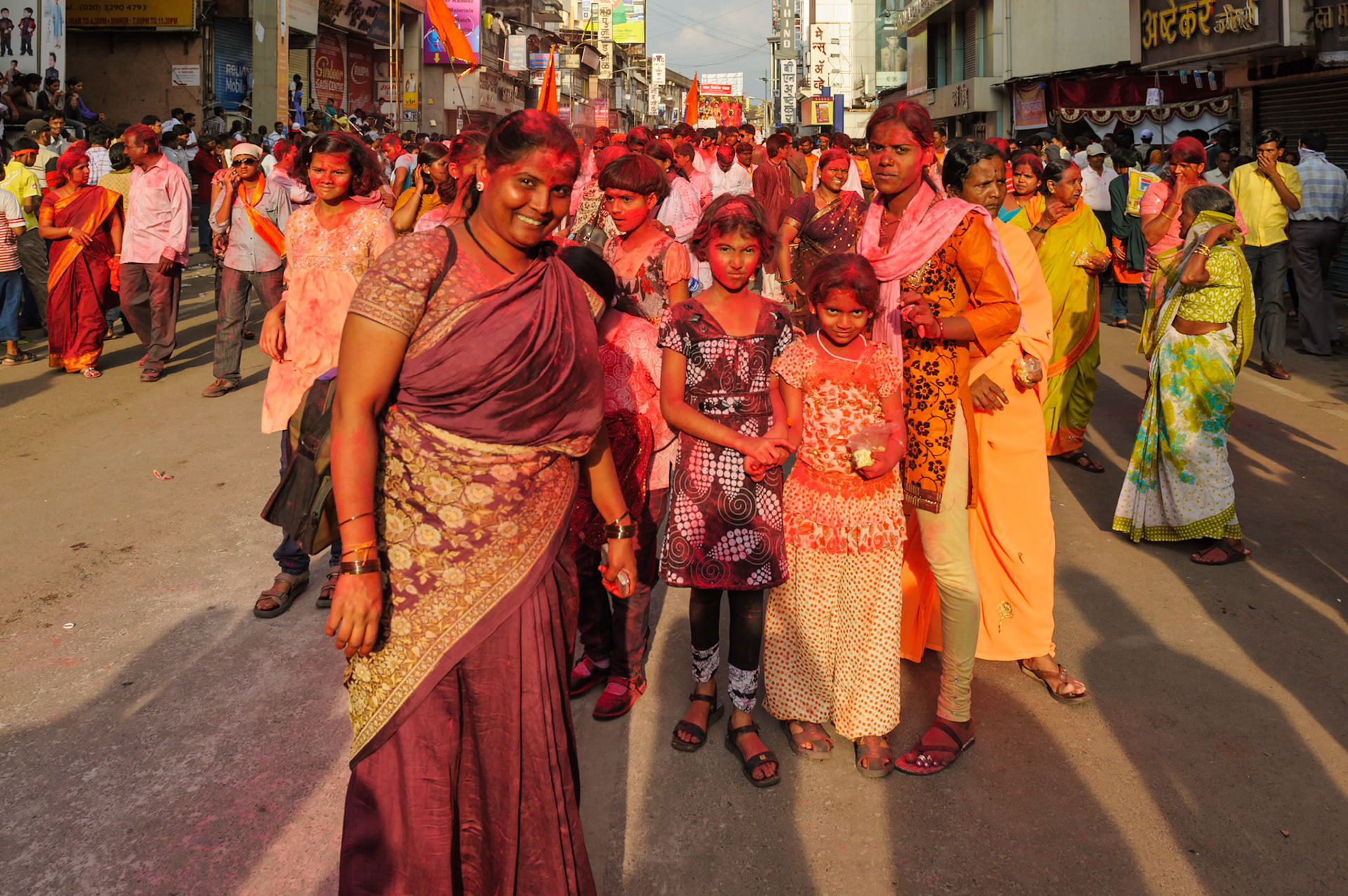 Pune, India Sep 22 -- A group of kids and women are covered from head to toe in red powder at the Ganesh/Ganpati festival parade on Sep 22, 2010 in Pune.