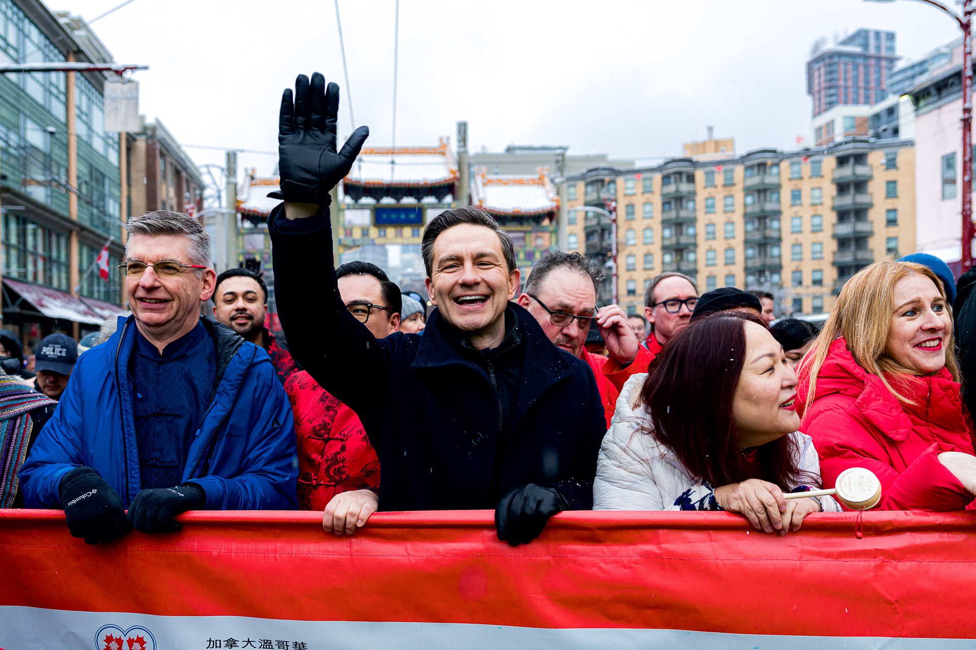 Pierre Poilievre waving to crowds in the snow.
