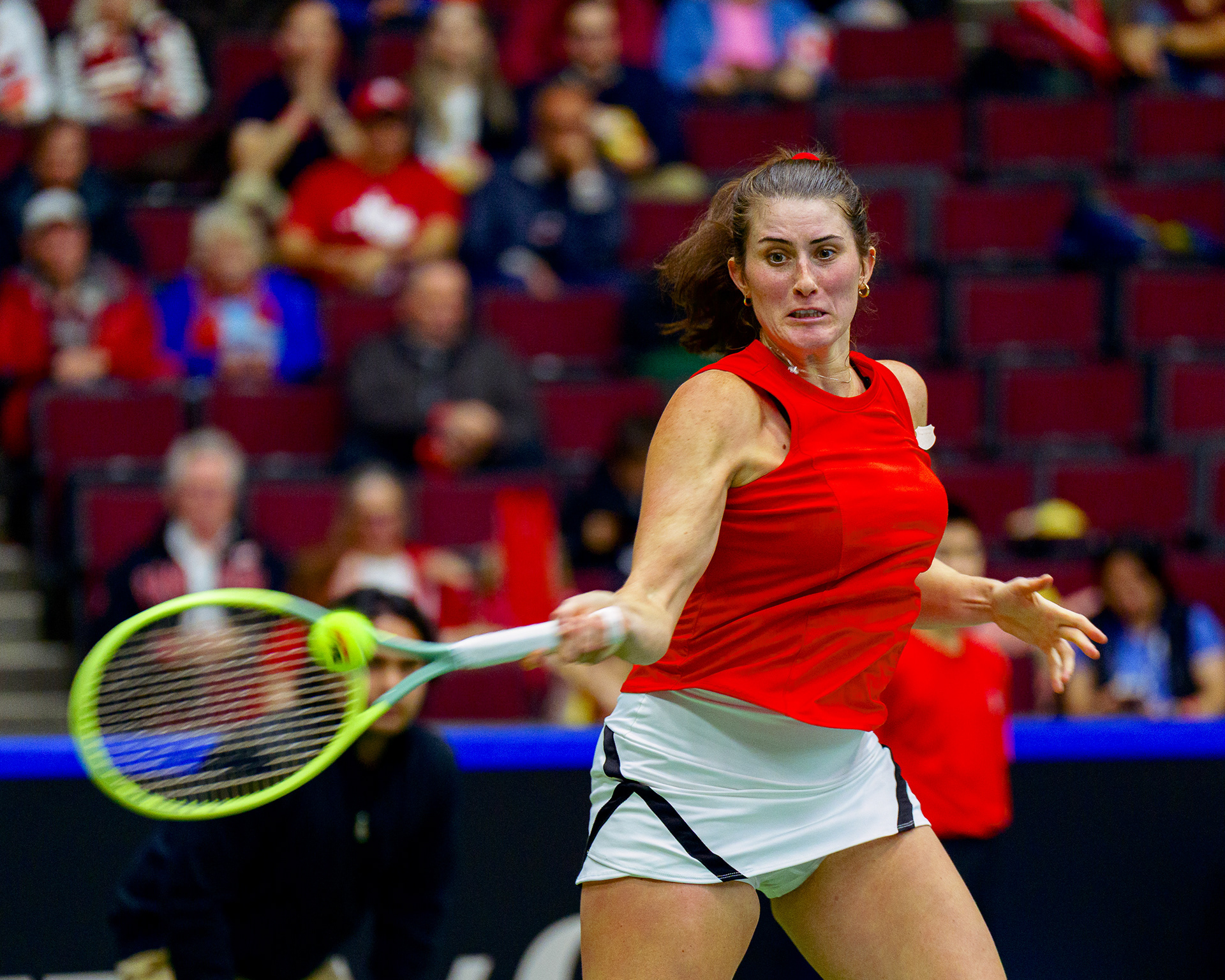 High-speed indoor tennis action photography on a Sony A1, utilizing Leica M9 High Saturation emulation to achieve dense red color weight and natural skin vitality under artificial stadium lighting.