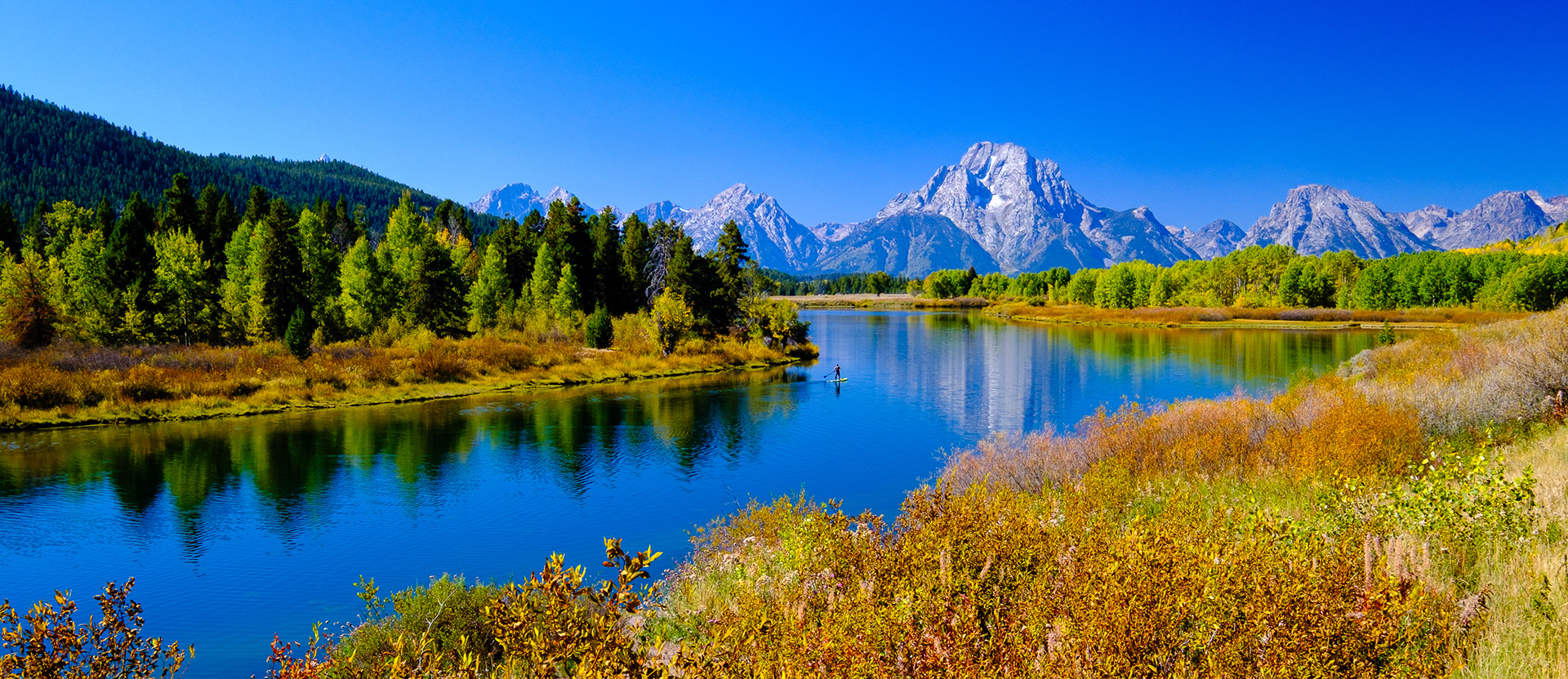 Grand Teton landscape edited with Fujifilm Velvia simulation showing crushed shadows and neon green grass.