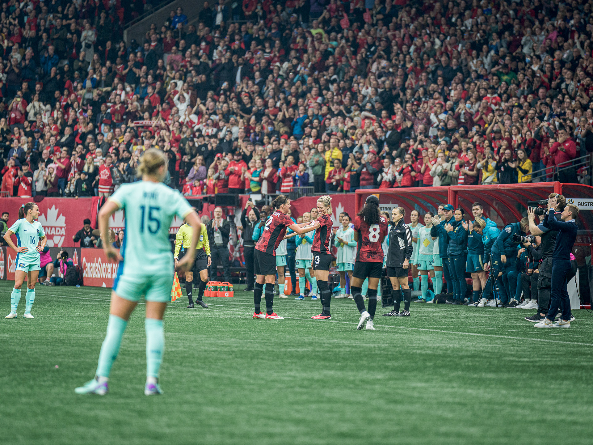 Historical moment of Christine Sinclair handing the captain's armband to Sophie Schmidt.