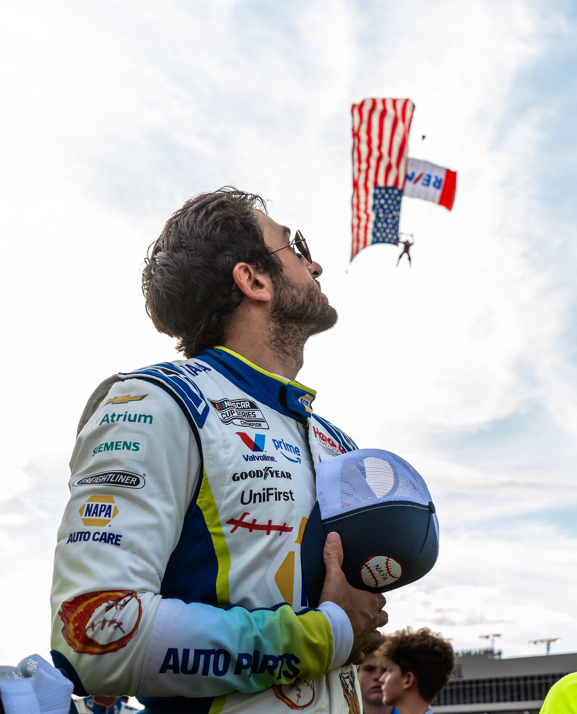  Skydiver descends over NASCAR Driver Chase Elliot amidst a Packed Crowd at Atlanta Motor Speedway