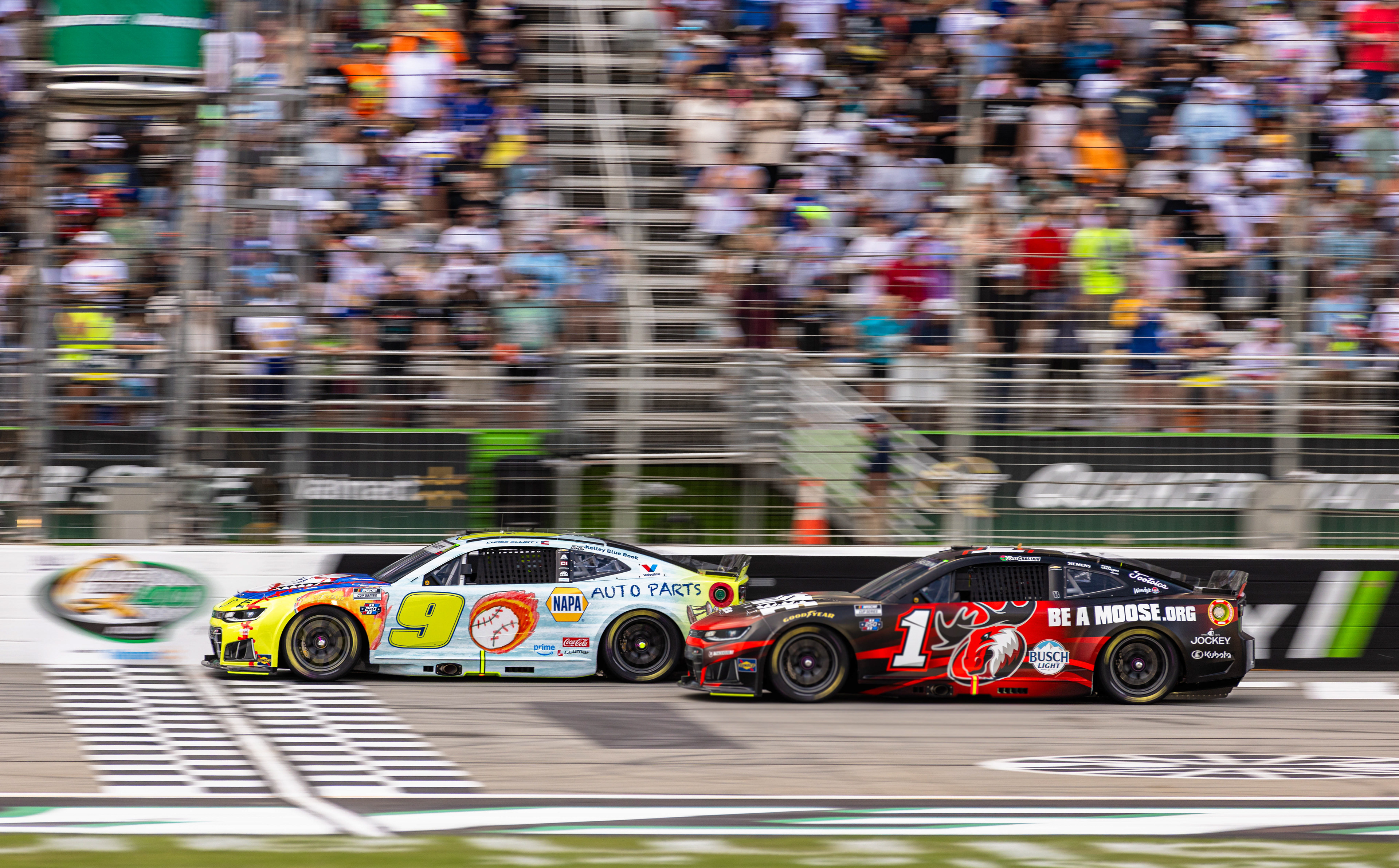 Chase Elliott overtakes Ross Chastain in the opening laps of his home race at EchoPark Speedway