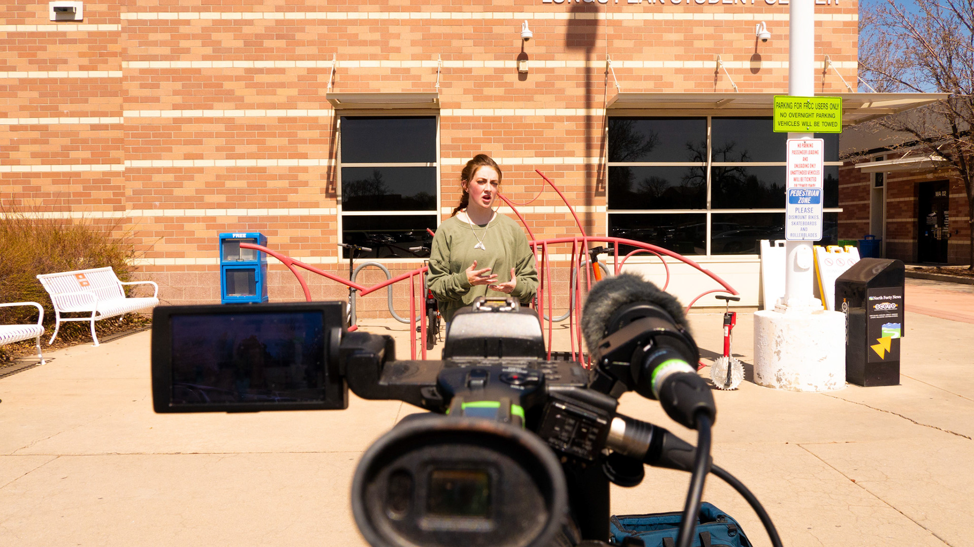Ren Wadsworth films a stand-up during her reporting outside Front Range Community College on April 18th, 2022.