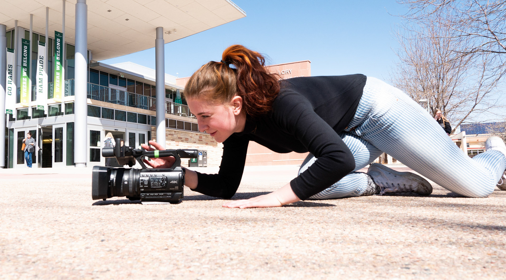 Ren Wadsworth gets low to grab a close up shot of students walking on the Plaza at Colorado State University on April 4th, 2022.