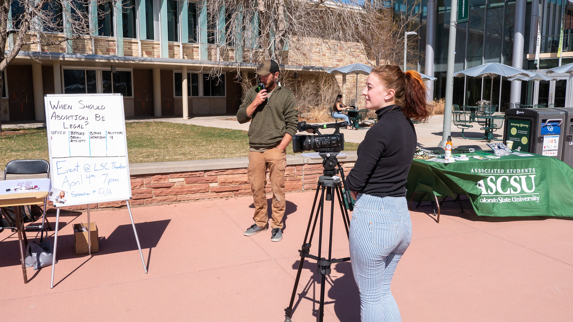 Ren Wadsworth captures footage of an Abortion sign while she speaks to a community member on the Plaza of Colorado State University on April 4th, 2022.